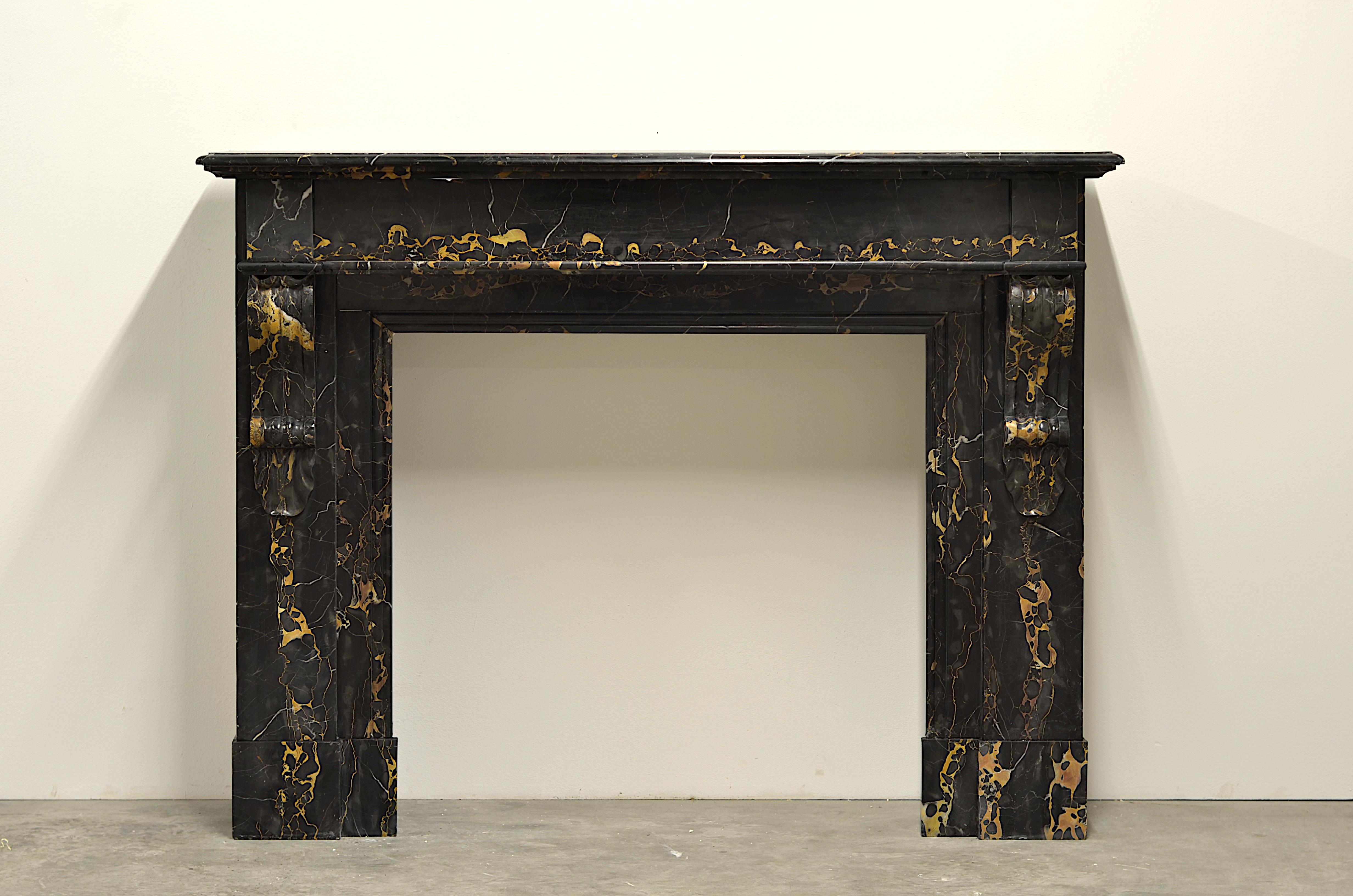 A very nice French fireplace mantel, executed in striking black and gold Italian Portoro marble.
This strong proportioned Louis Philippe console style fireplace is from the center of Paris.
Created in early 19th Century is adorned a beautiful