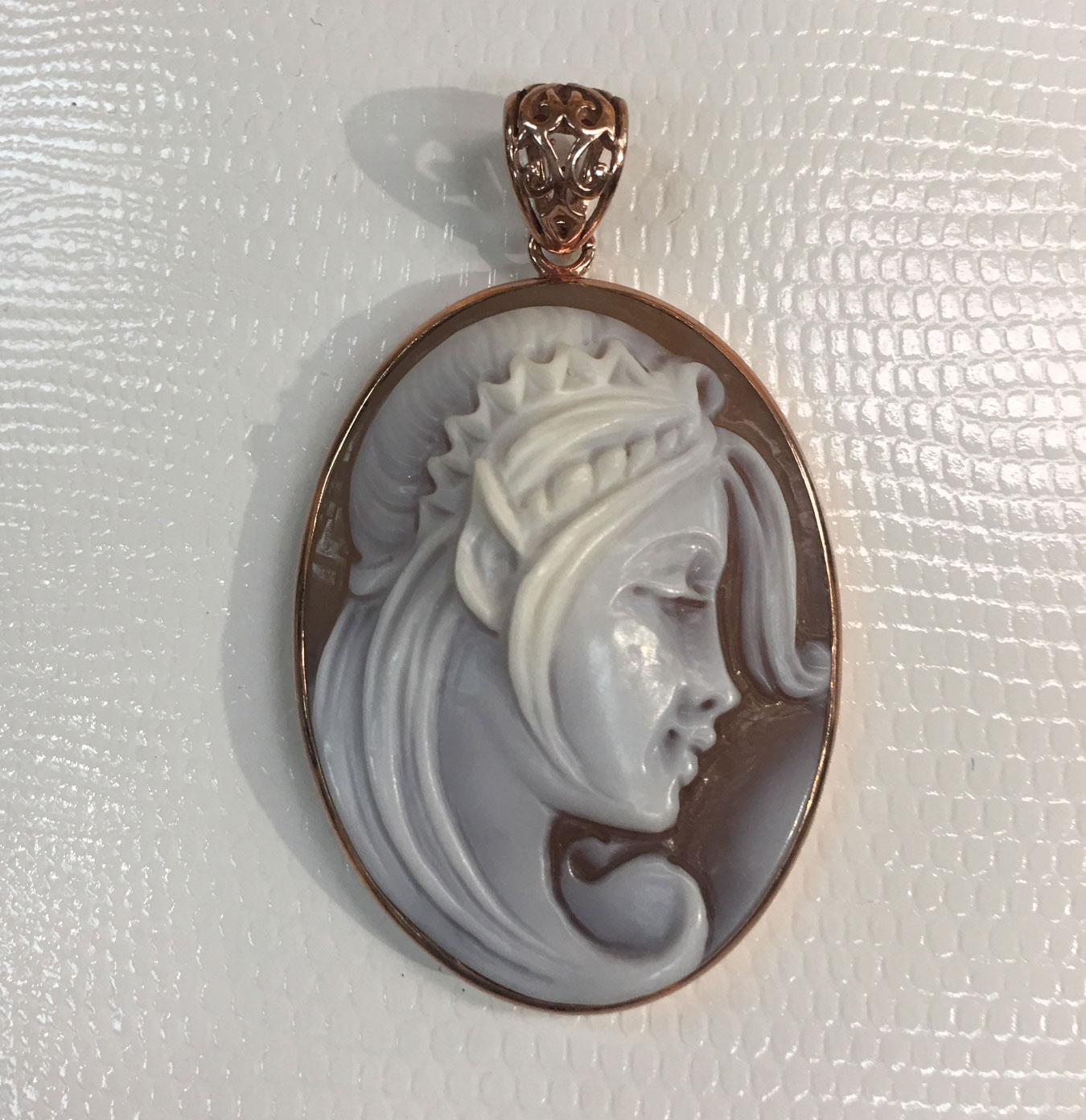 Hand carved shell Cameo Pendant depicting the Profile of a Classical Beauty with long flowing hair, set in a Rose Gold Sterling Silver mounting. Rendered with remarkable detail and warmth, so unusual to find! Measuring approx. 2 inches x 1.25