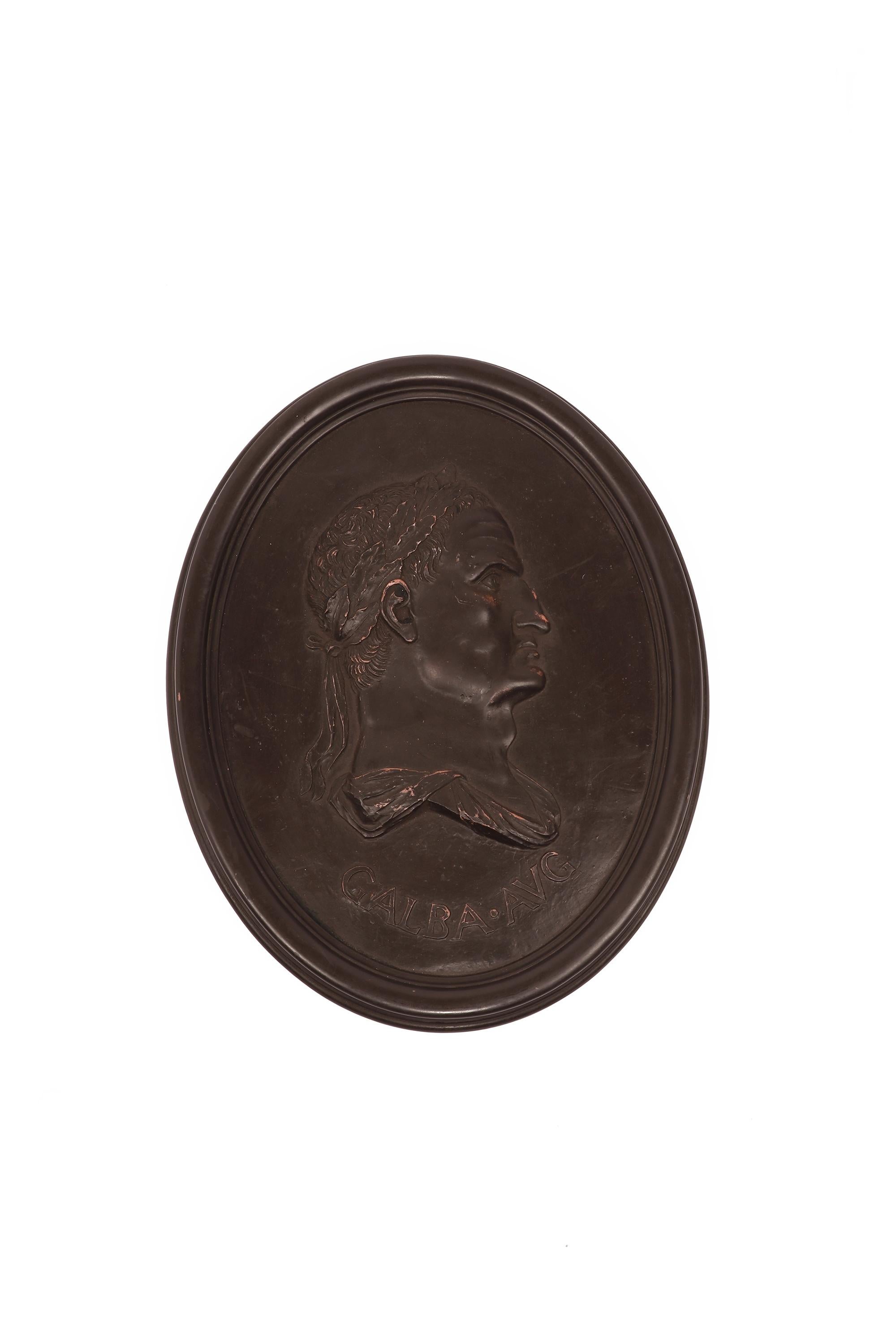 These oval medallions, sold individually, feature profile portraits of two Roman Caesars rendered in low relief against a textured background. Each medallion is inscribed with the subject's title, adding an element of historical authenticity. The