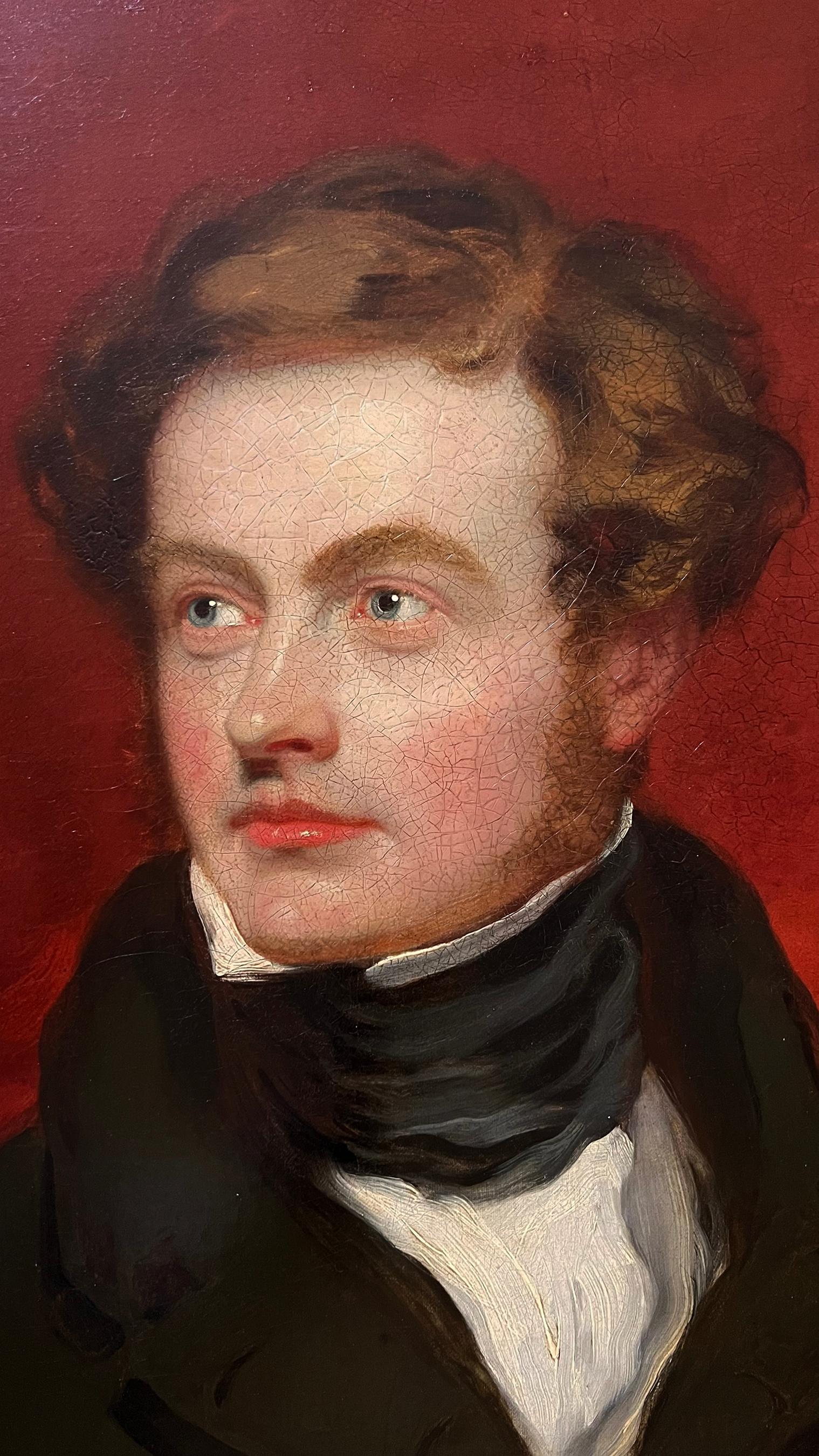 A handsome Regency or early Victorian blue-eyed gentleman from the school of Sir Thomas Lawrence (1769-1830). The fashionably dressed young man sports a frock coat with a high collar and charcoal silk cravat. He wears his auburn hair a windswept