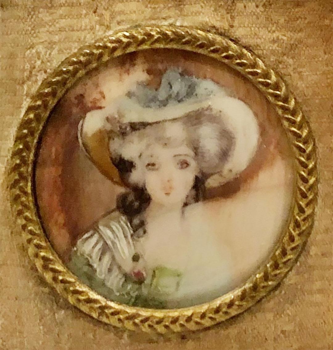 French picture is ivory of a beautiful girl in a white hat. It is signed bun can not make it out. Bronze jewelry frame with a beautiful little bow on the top. Circa 1910s.