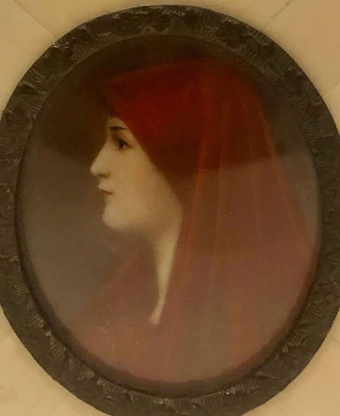 Portrait of girl with a shawl on her head in an ivory frame. The back is an early piece of French fabric. France, circa 1890s.