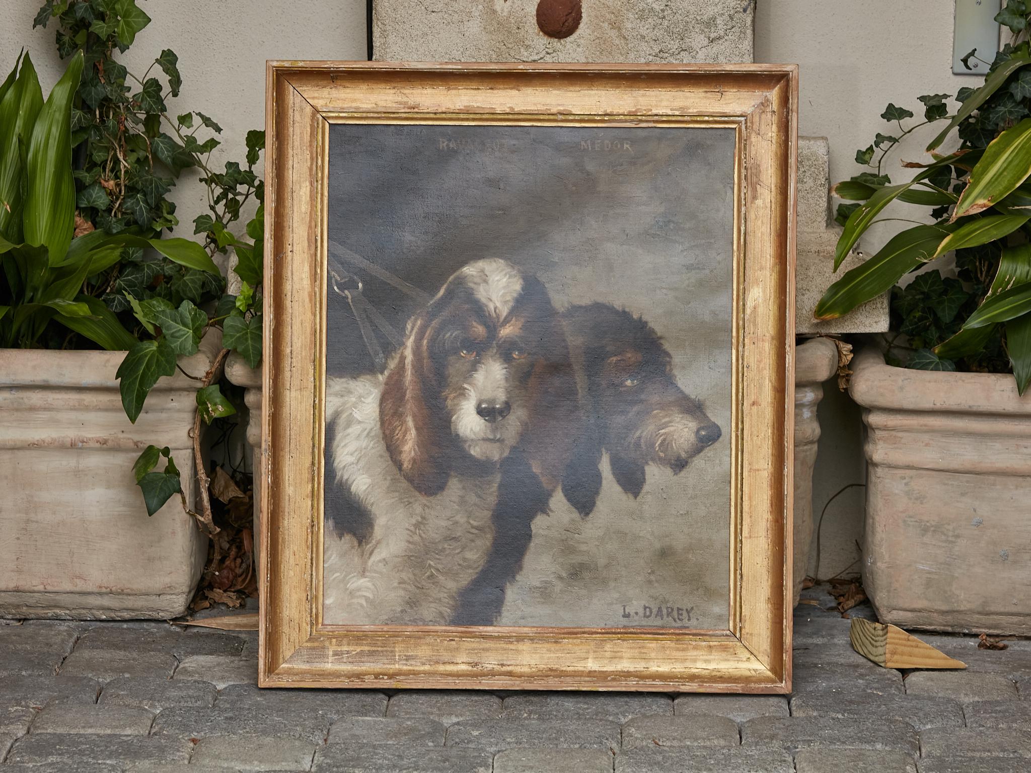 A French oil on canvas painting by Louis Darey (1848-1917) depicting a pair of Bassets hunting dogs from circa 1880 in gilt frame. Step into the world of French Realism with this exquisite oil on canvas painting by Louis Darey (1848-1917), capturing