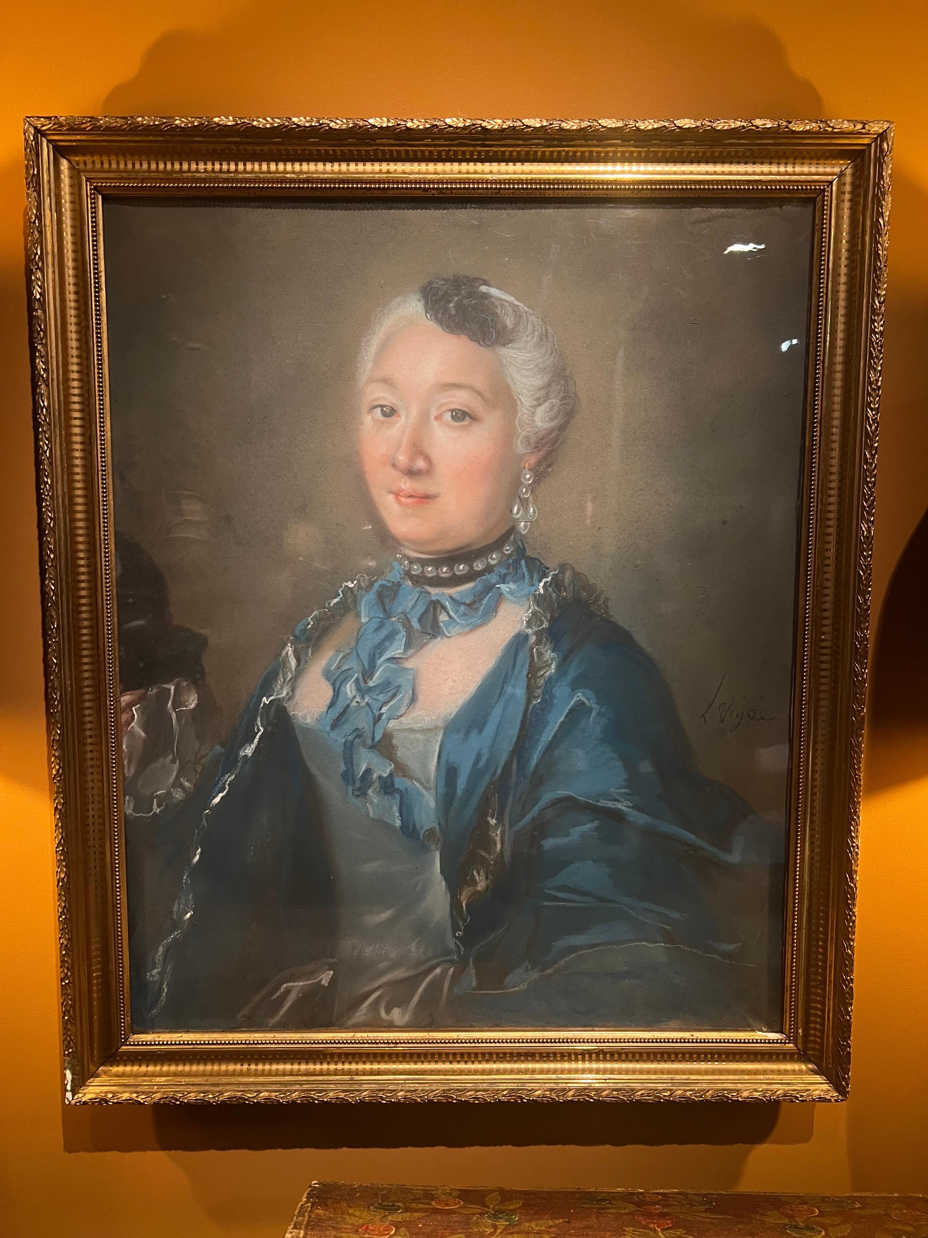 This exquisite portrait of a woman in a striking blue dress is a masterful work by Louis Vigée, painted in pastel on paper, mounted on canvas. Signed by the artist in the lower right, L. Vigée, this piece beautifully captures the elegance and grace