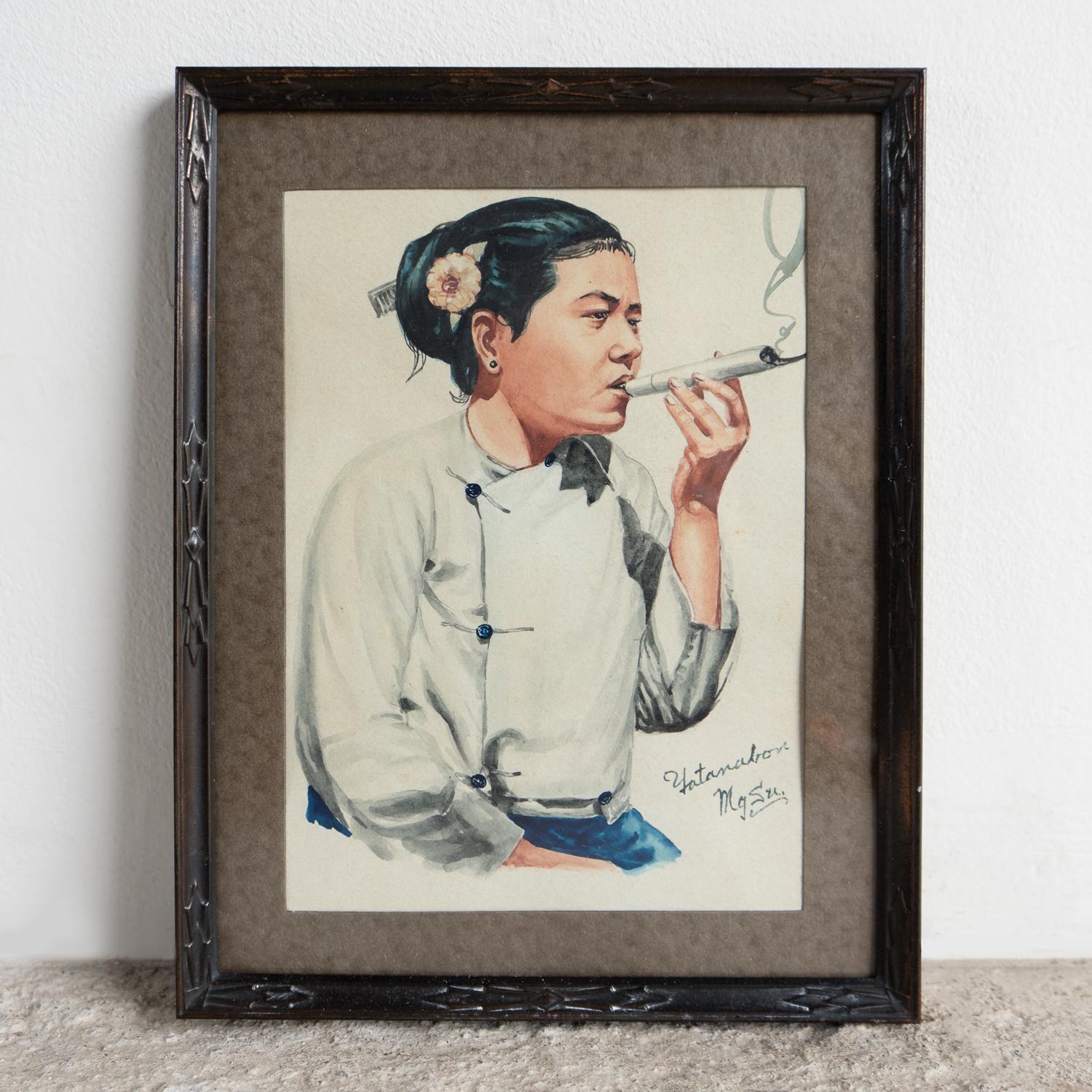 VINTAGE ORIGINAL WATERCOLOUR ON PAPER PAINTING DEPICTING A FEMALE SITTER, MID 20TH CENTURY 

‘BURMESE WOMAN, CHEROOT SMOKER, MANDALAY’ BY YATANABON MAUNG SU, BURMESE (1903-1965). 

A typically characterful portrait by the artist, well known for