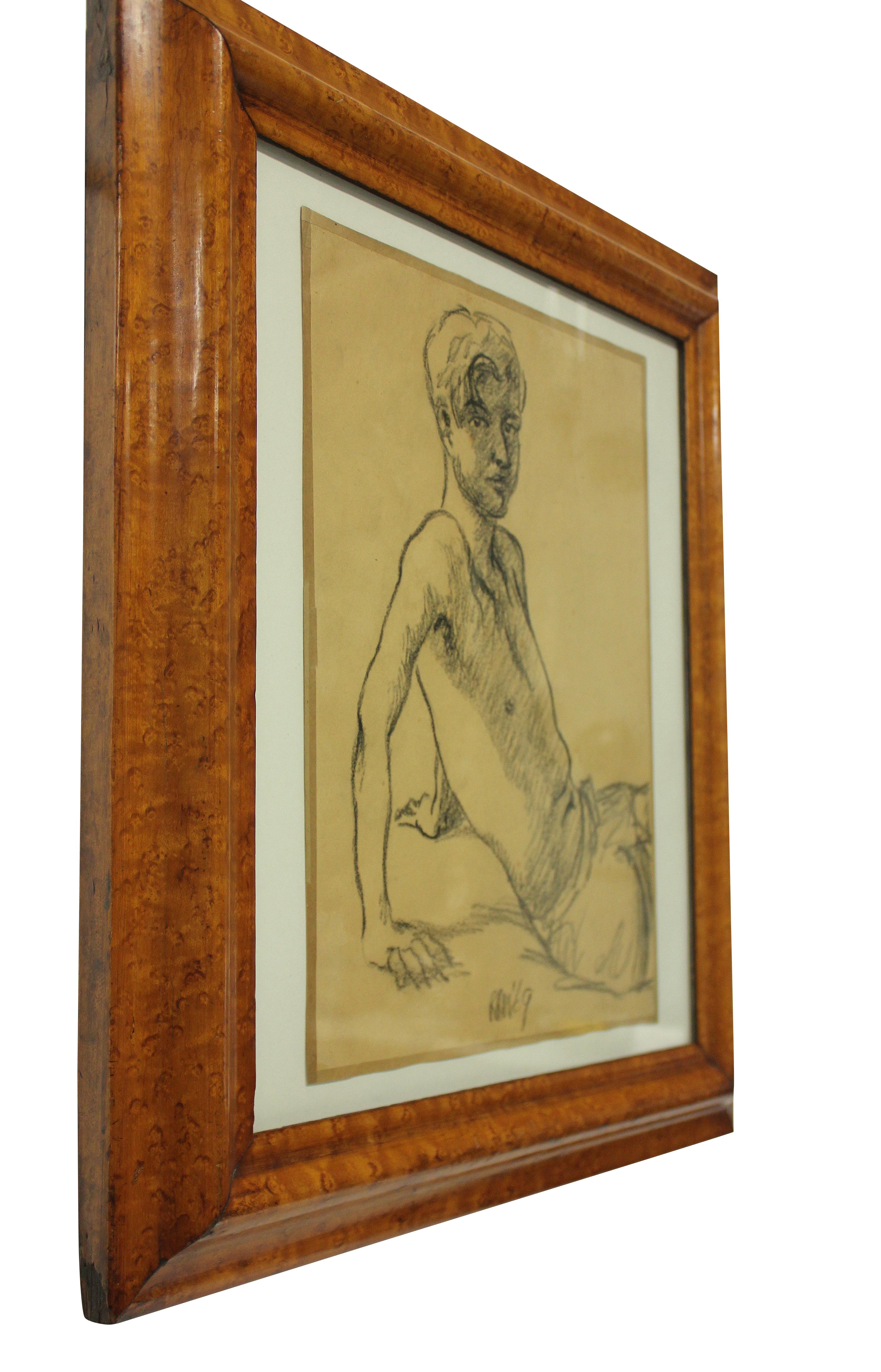 An English portrait of a young man in charcoal on parchment, framed in walnut. Dated and signed 1969.