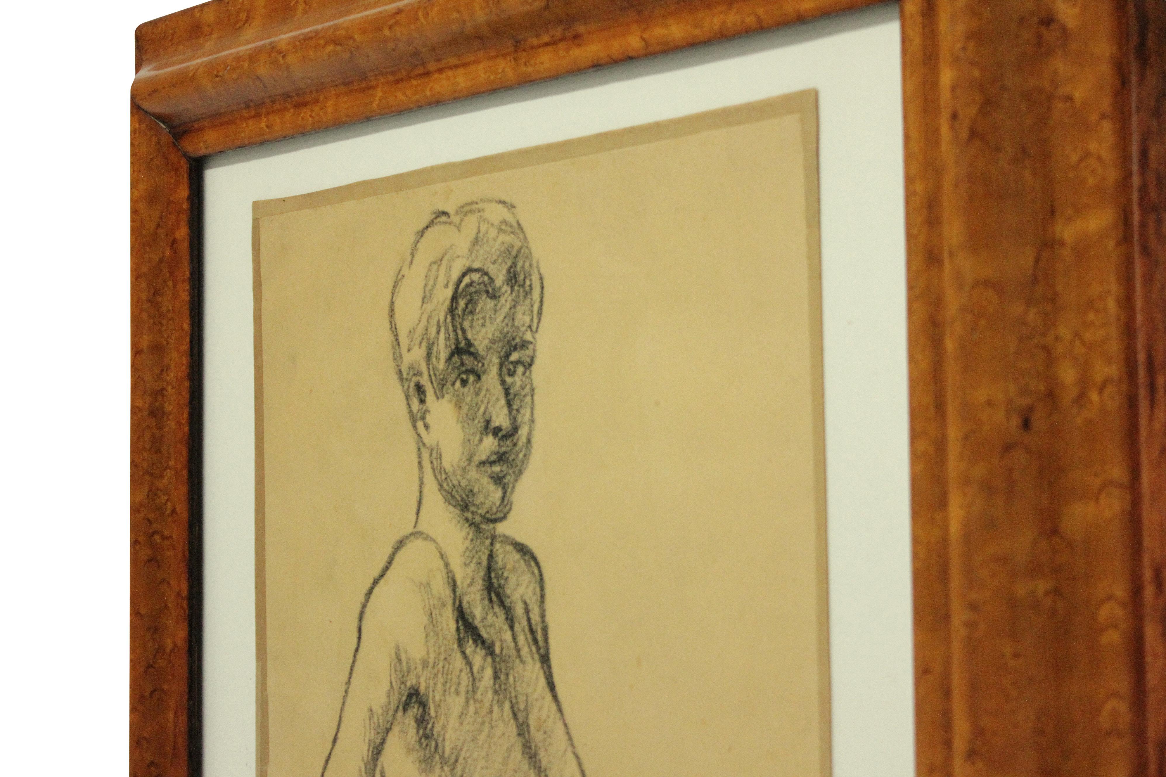 An English portrait of a young man in charcoal on parchment, framed in walnut. Dated and signed 1969.