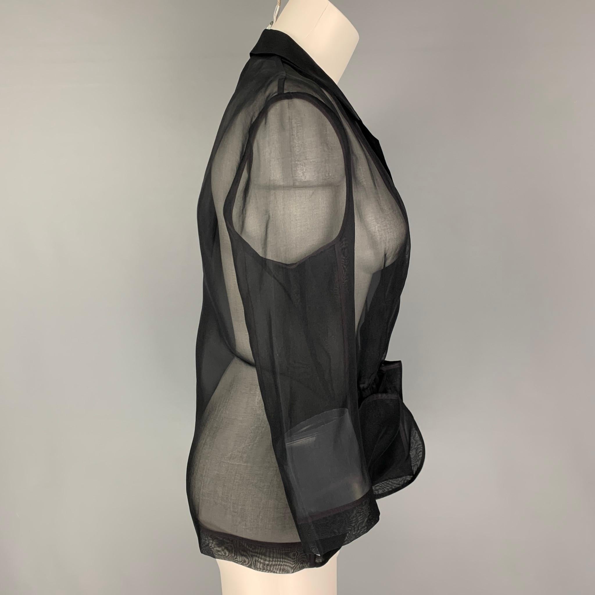 PORTS 1961 jacket comes in a black see through silk featuring a notch lapel, patch pockets, and a sel tie belted closure. 

Very Good Pre-Owned Condition.
Marked: 10

Measurements:

Shoulder: 16 in.
Bust: 38 in.
Sleeve: 19 in.
Length: 25 in. 


