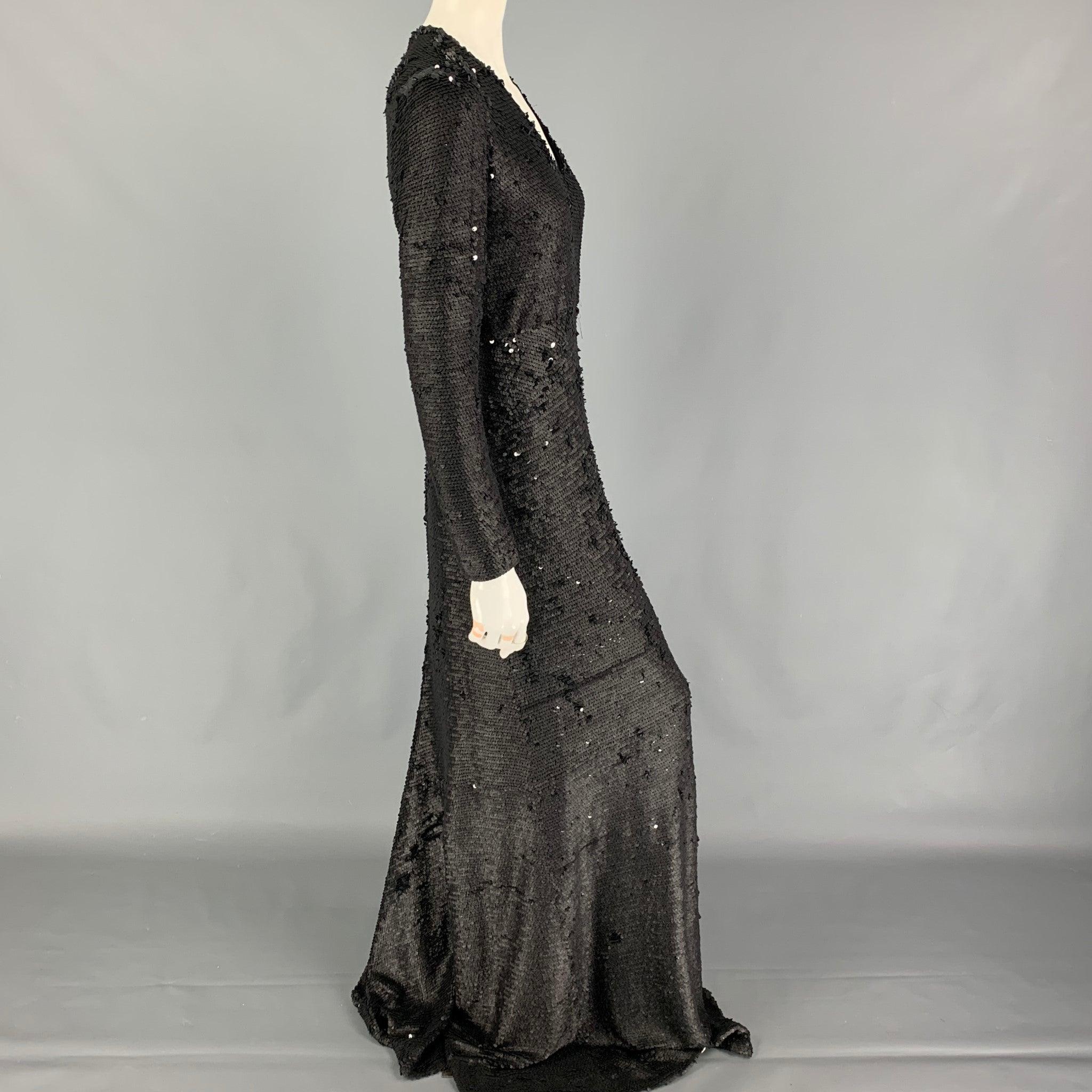 PORTS 1961 dress comes in a black sequined polyester blend featuring long sleeves, v-neck, and a back zip up closure.
Very Good
Pre-Owned Condition. 

Marked:   42 

Measurements: 
 
Shoulder: 13 inches  Bust: 32 inches  Waist: 28 inches  Hip: 30