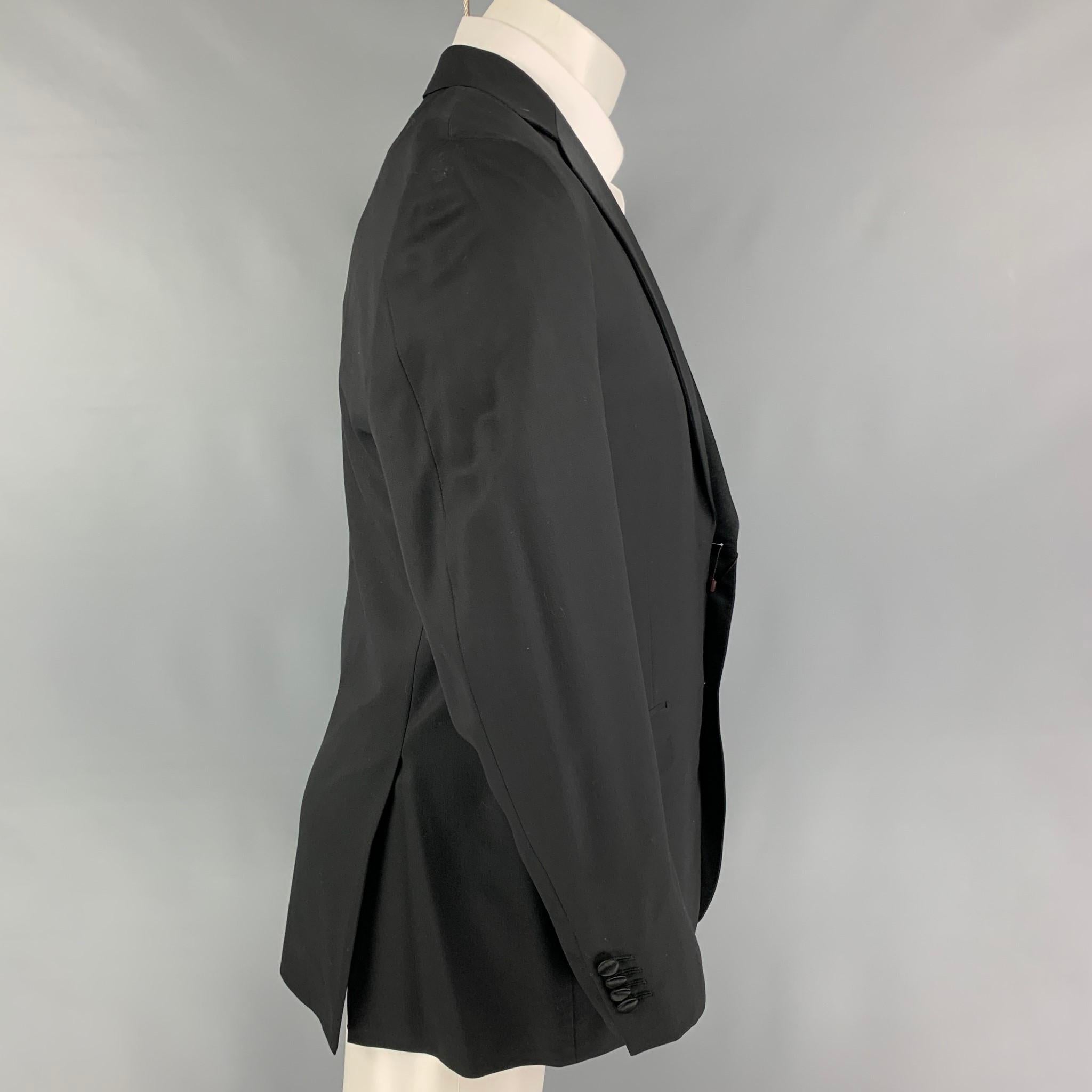 PORTS INTERNATIONAL tuxedo sport coat comes in a black wool with a full red liner featuring a notch lapel, flap pockets, double back vent, and a double button closure. Includes tags.

Very Good Pre-Owned Condition. Missing one button closure.