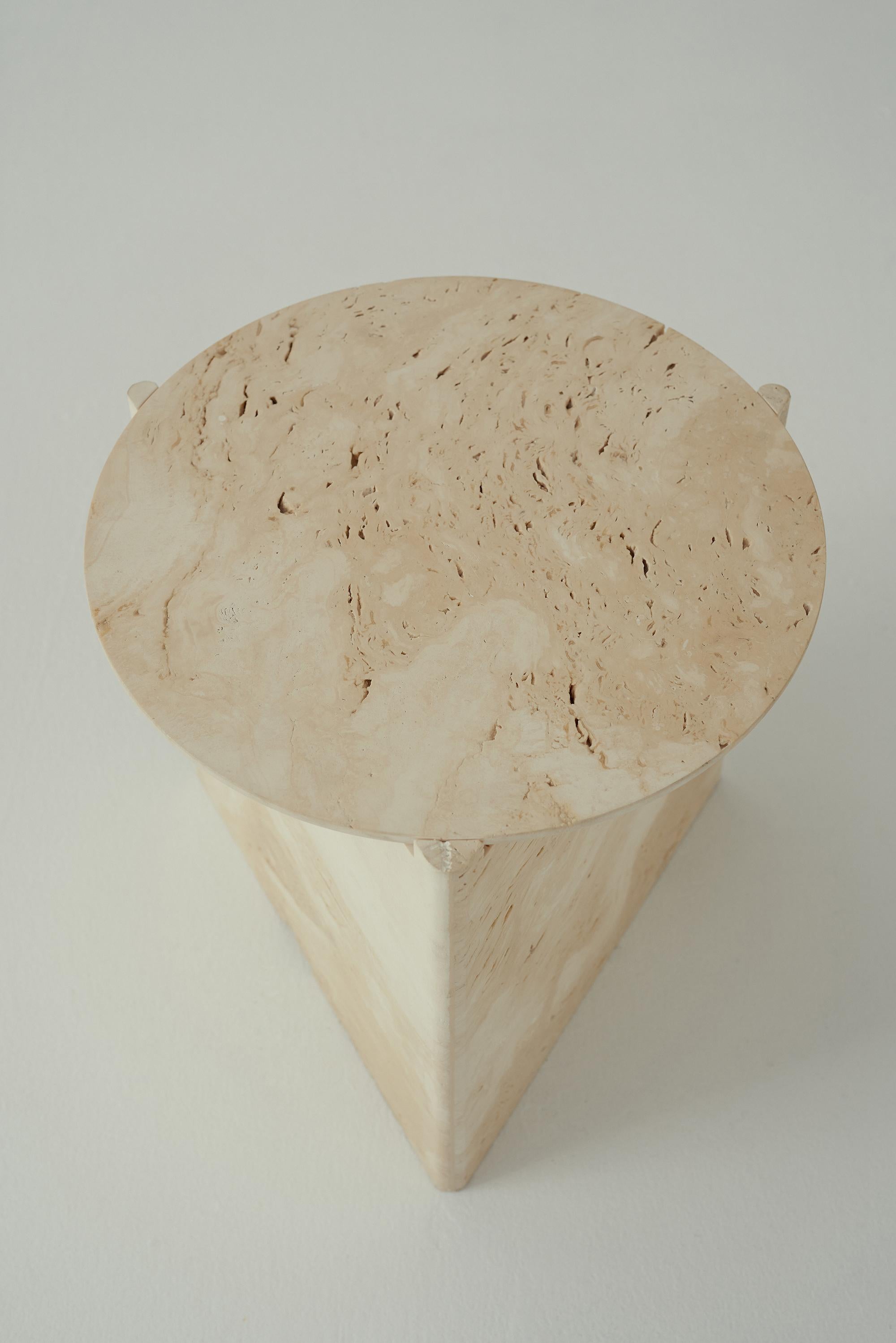 The Portsea side table celebrates elemental forms and quality craftmanship; a
reimagining of the Malibu Side Table in figured natural stone.

Travertine gives tactile dimension to the table’s circular and triangulated forms, with fine stone