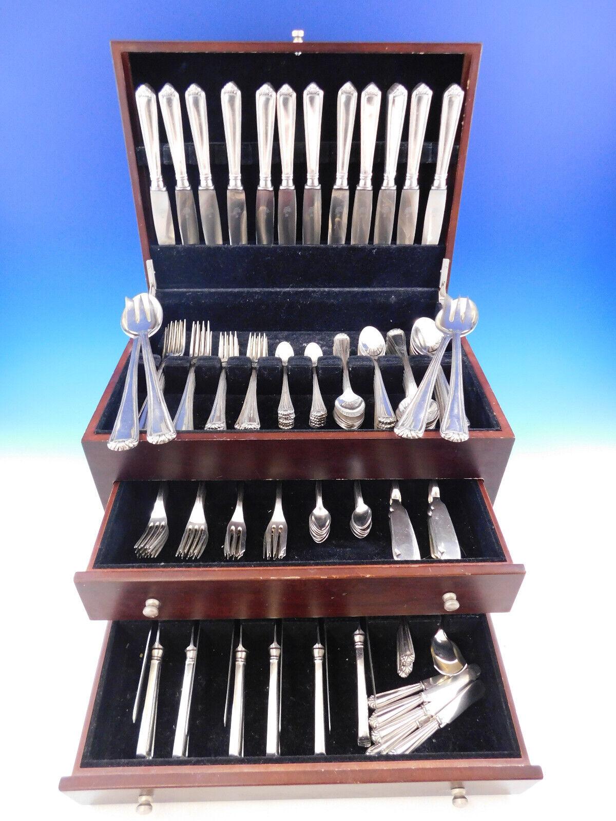 Monumental Portuguese .833 silver flatware set with scroll design. Pieces are well balanced and heavy. This set includes:

12 dinner knives w/stainless blades, 9 1/4