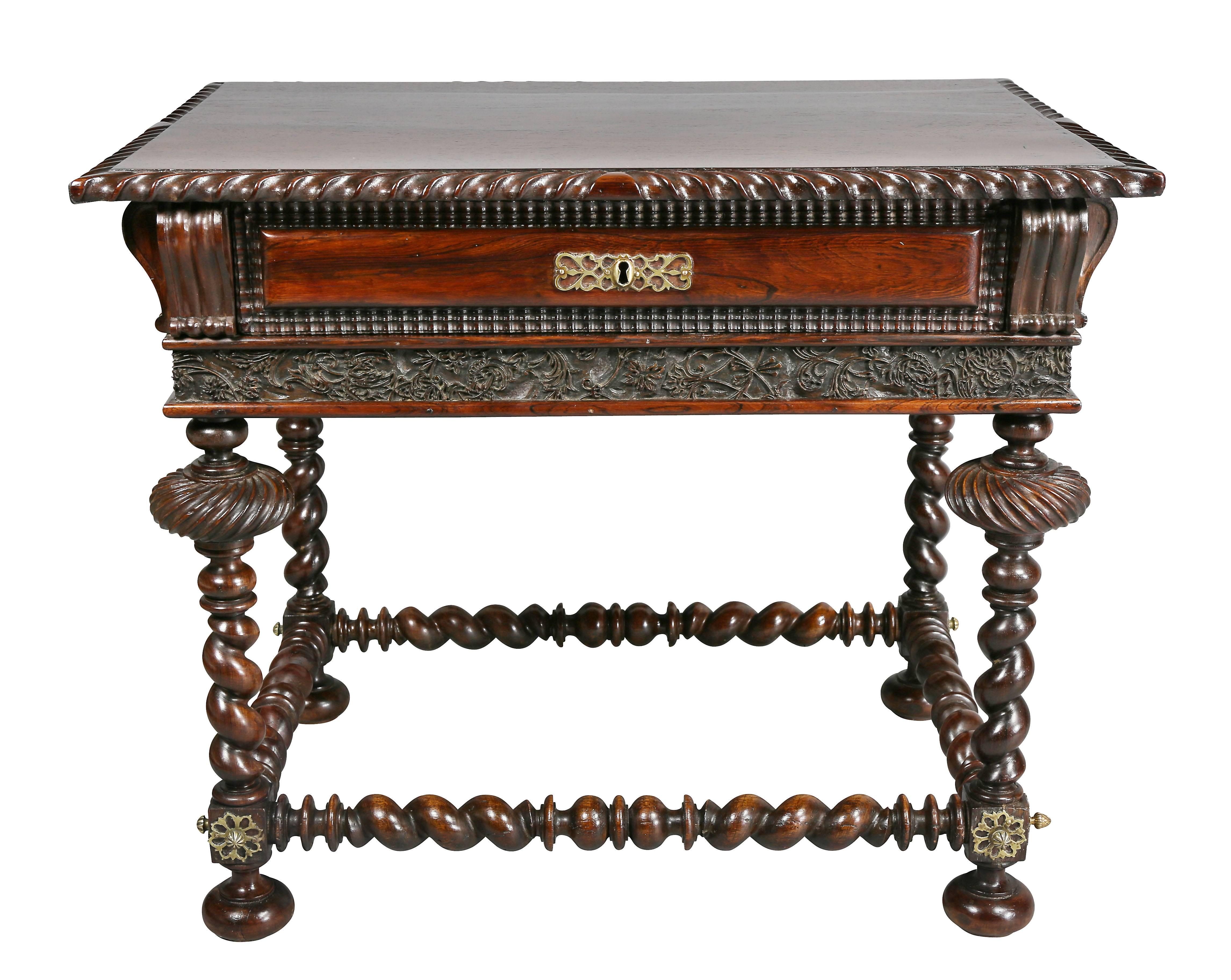 With rectangular top with gadrooned edge over a drawer with all around false drawers and carved frieze, over a carved frieze, raised on barley twist legs joined by a conforming box stretcher with brass mounts and bun feet.