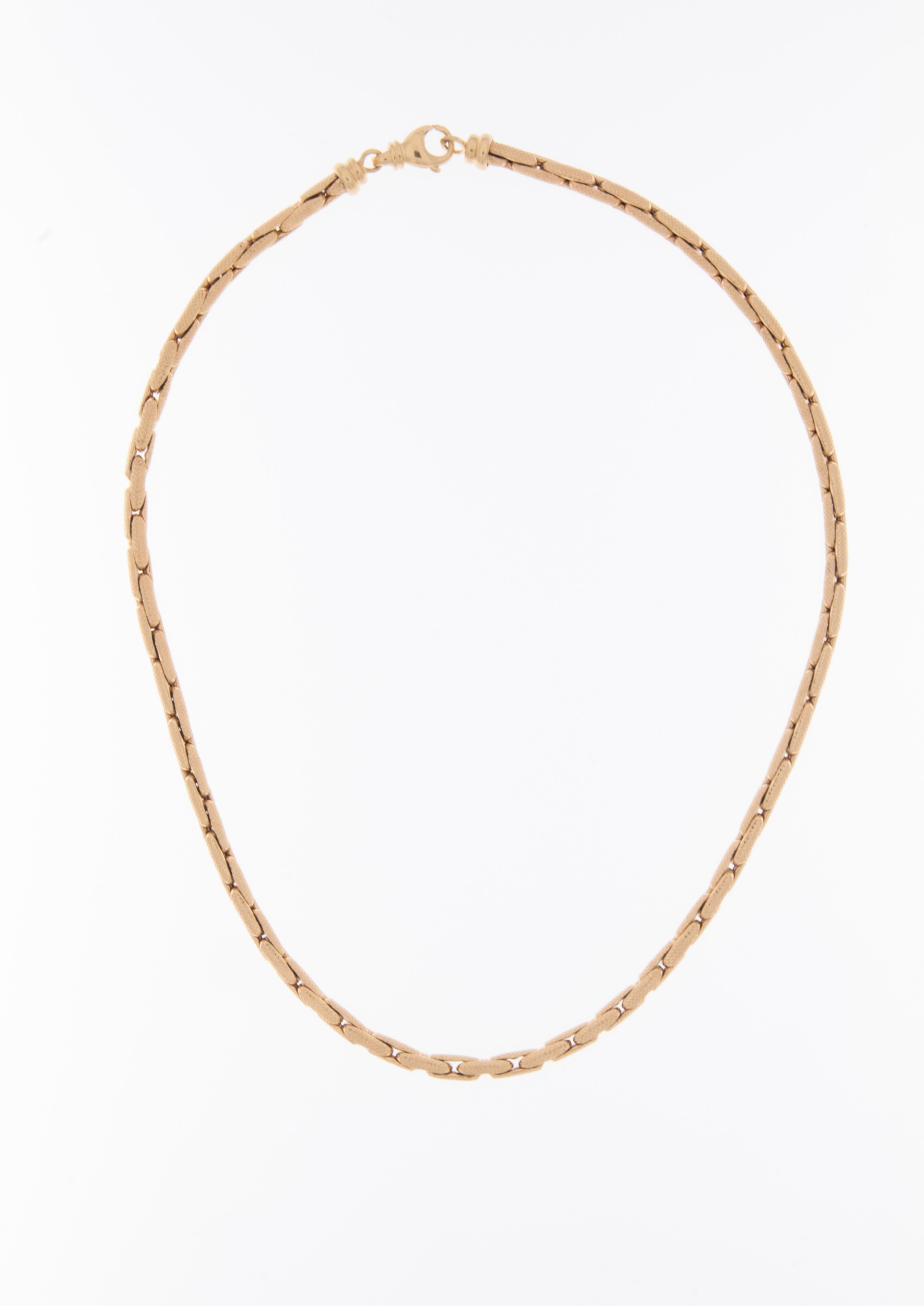 The Portuguese 19kt Yellow Gold Chain Necklace with a satin finish and relief work is a beautifully crafted and distinctive piece of jewelry. 

This exquisite necklace is made from high-quality 19-karat yellow gold, known for its rich color and