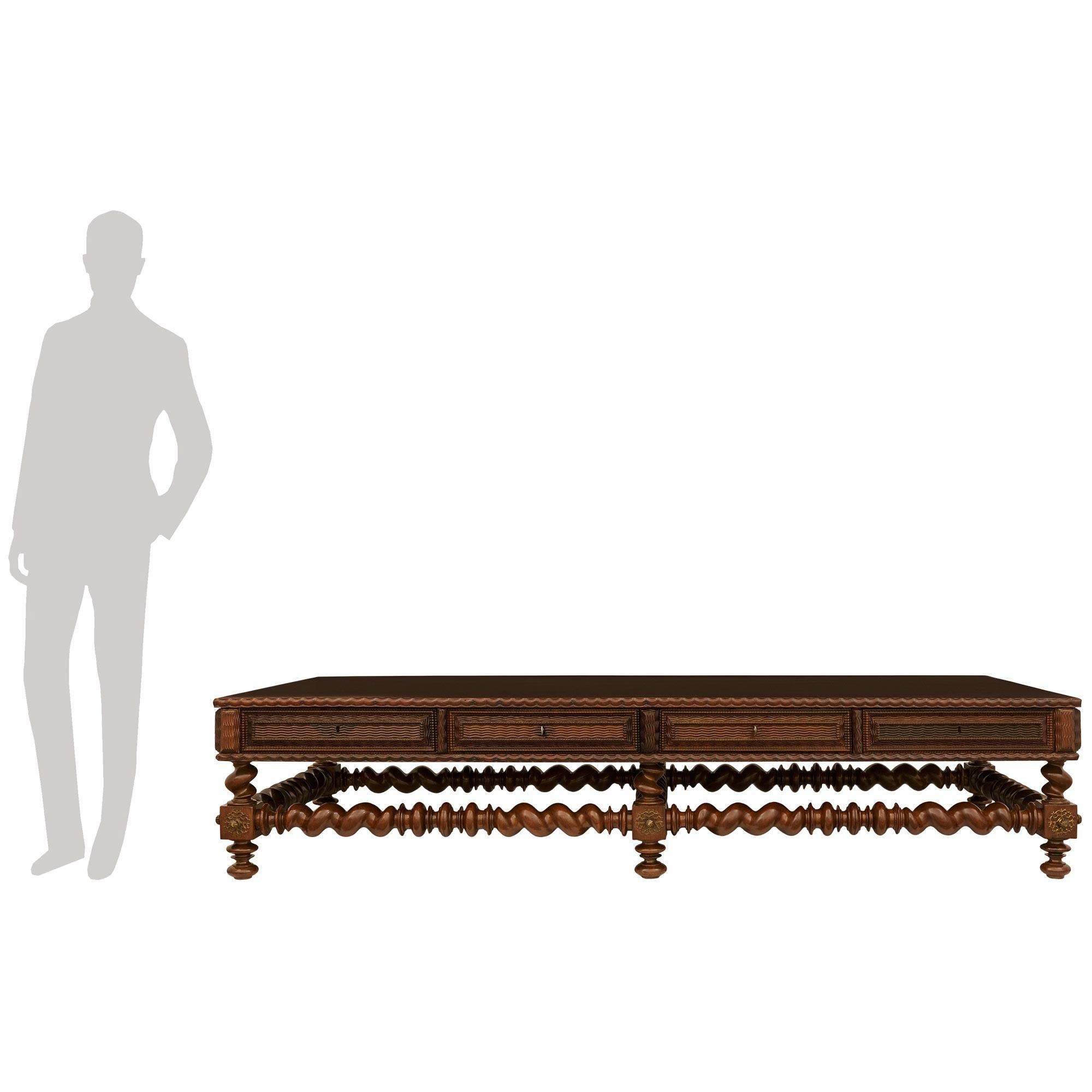 An impressive and most handsome Portuguese 19th century Rosewood and Gilt Metal coffee table. This stunning rectangular table is raised by six toupie shaped feet leading to square blocks decorated with pierced Gilt Metal rosettes joined together by