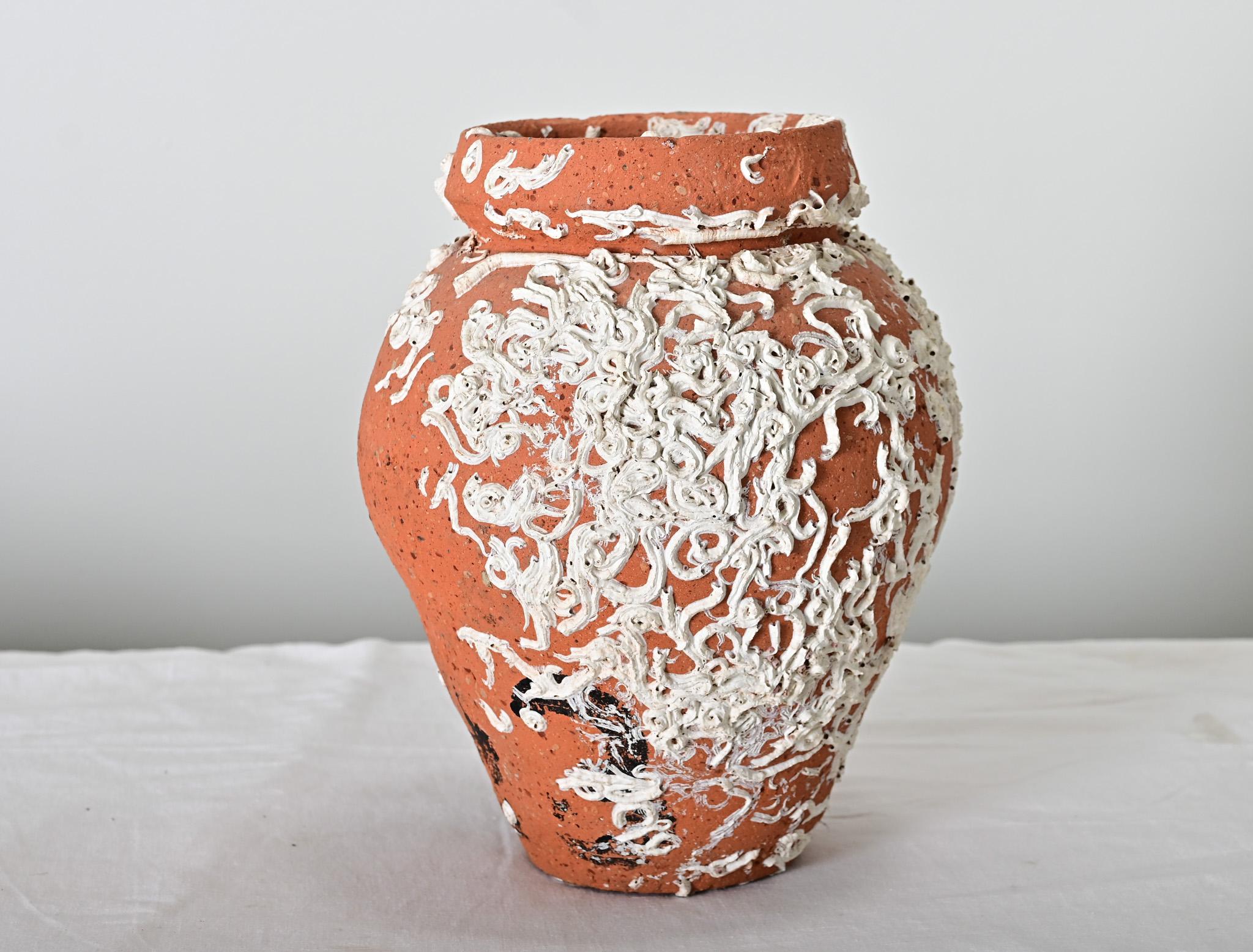 Handmade terracotta pots like these, found around the Mediterranean and Japan, are used for catching octopus: the narrow neck would have been tied with a rope to retrieve the pot from the seafloor. This 19th century Portuguese example has been left