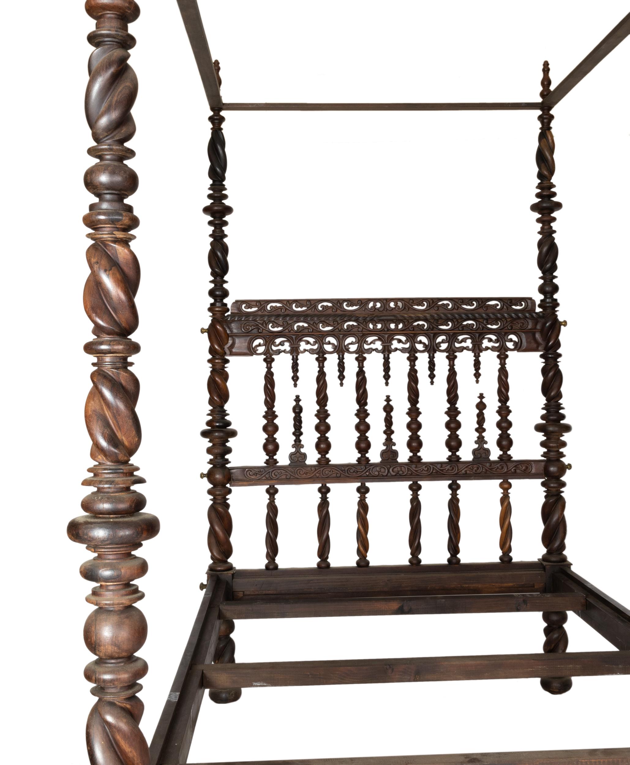 A Baroque four-poster bed (ceiling), with headboard.
The headboard, decorated with boned shaped, shakes and strings, are turned into bobbin-shaped discs and balls in the sides and the legs of the bed. 
The columns are turned into balls, discs and