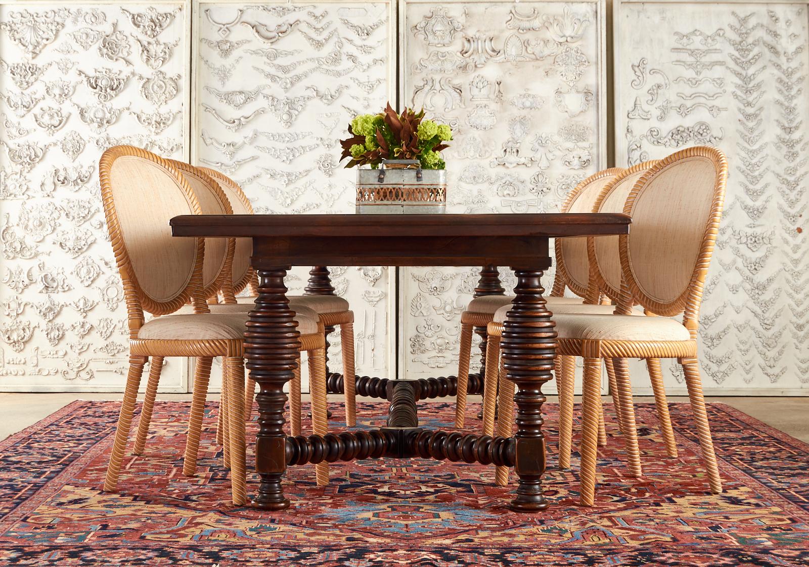 Magnificent Portuguese baroque style farmhouse dining table hand-crafted in Italy. The large rustic table features a thick rectangular top having three geometric parquetry inlay patterns. Supported by substantial turned spool legs ending with disc