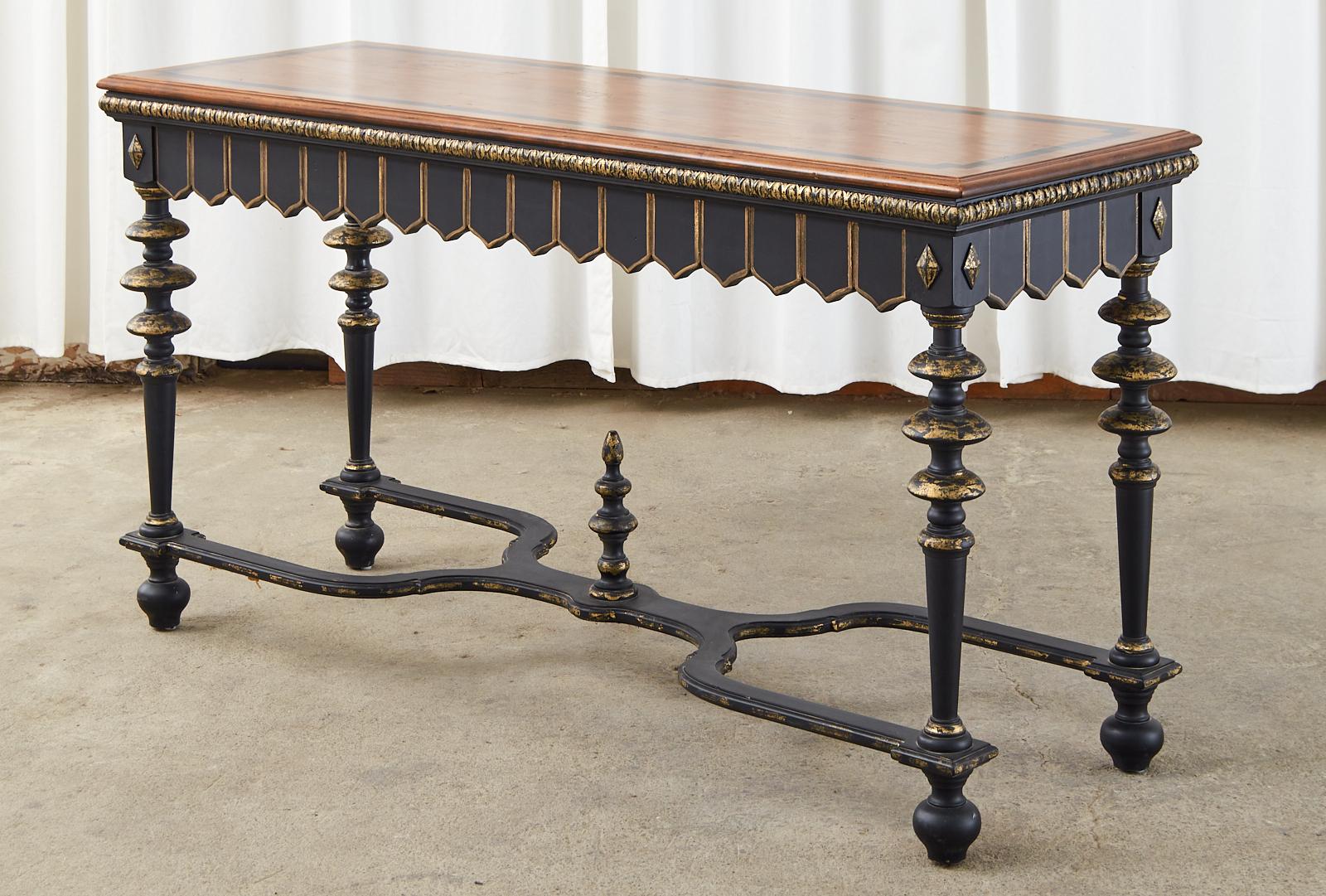 Stunning ebonized console table or library table crafted in the Portuguese Baroque style the table features a gadrooned border above the frieze with geometric shaped moldings below. The trestle style base has dramatic turned legs ending with ball