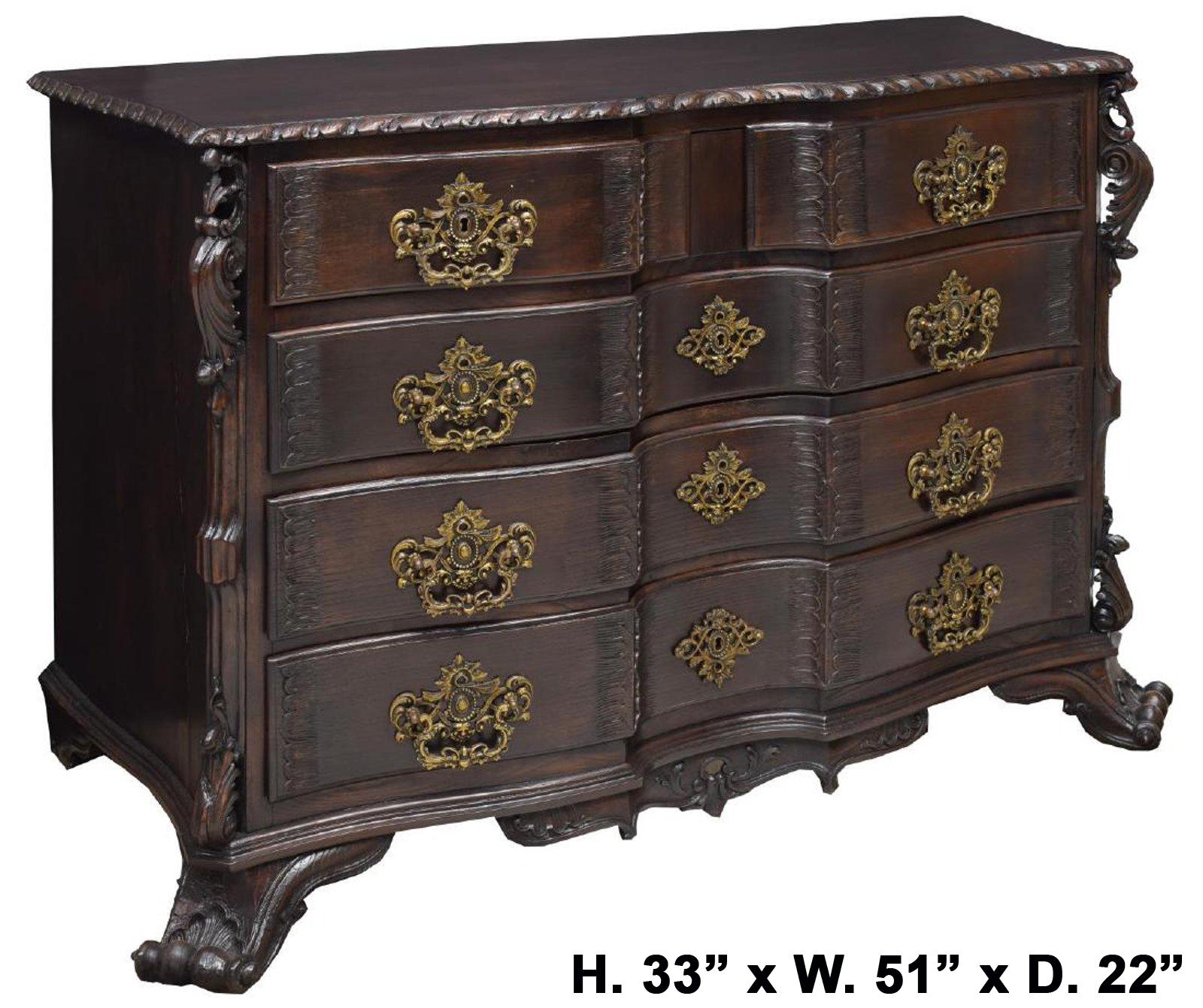 Extraordinary 19th century Portuguese carved five drawer break-fronted commode.
The moulded top is over two short drawers and three long drawers mounted with intricately decorated bronze handles, above an apron carved with a shell and foliage