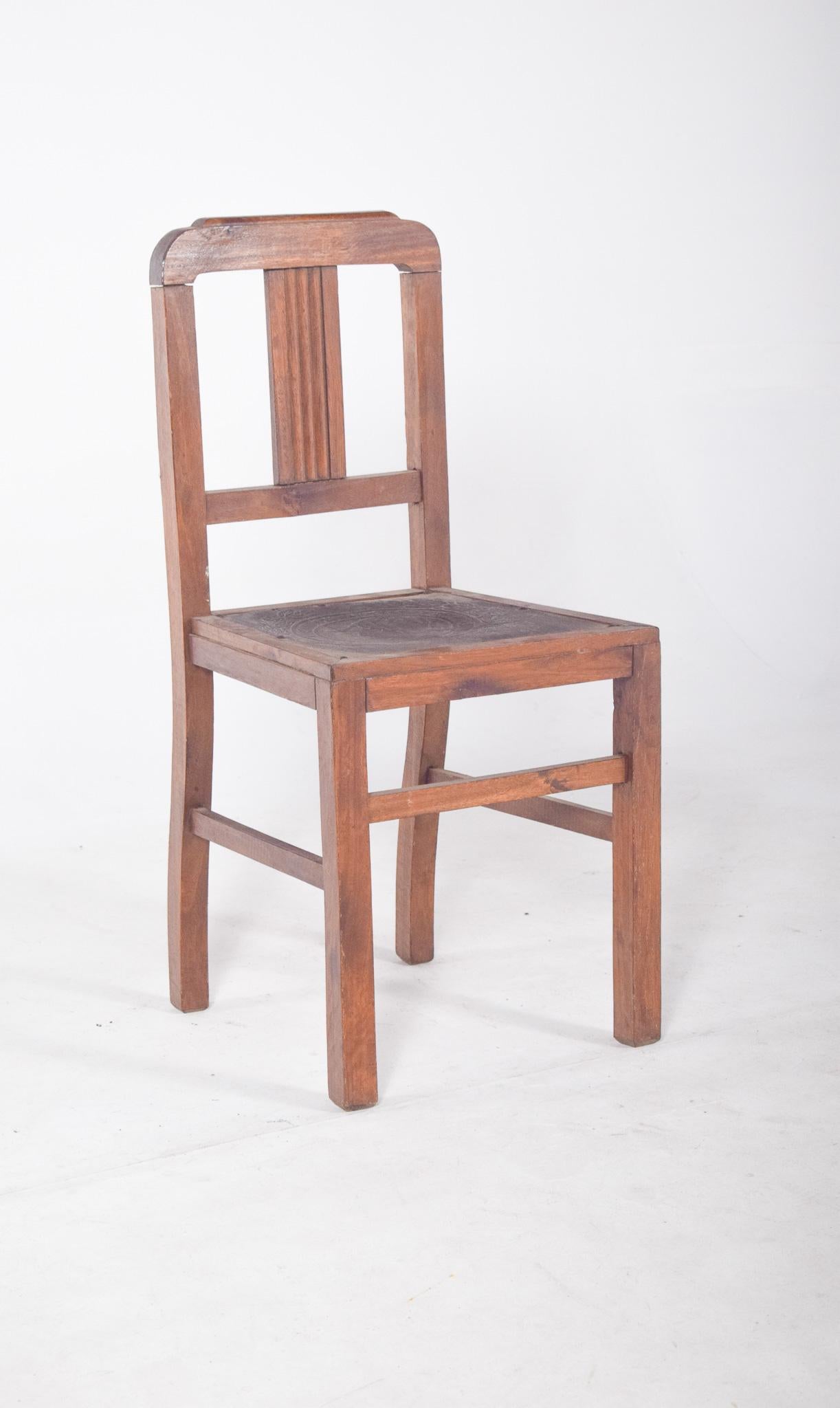 Portuguese chair with engraved leather and studs. Traditional Portuguese style, in solid wood with a straight back and simple structure, with straight lines and robust shapes. The seat is covered in leather engraved with delicate bas-relief