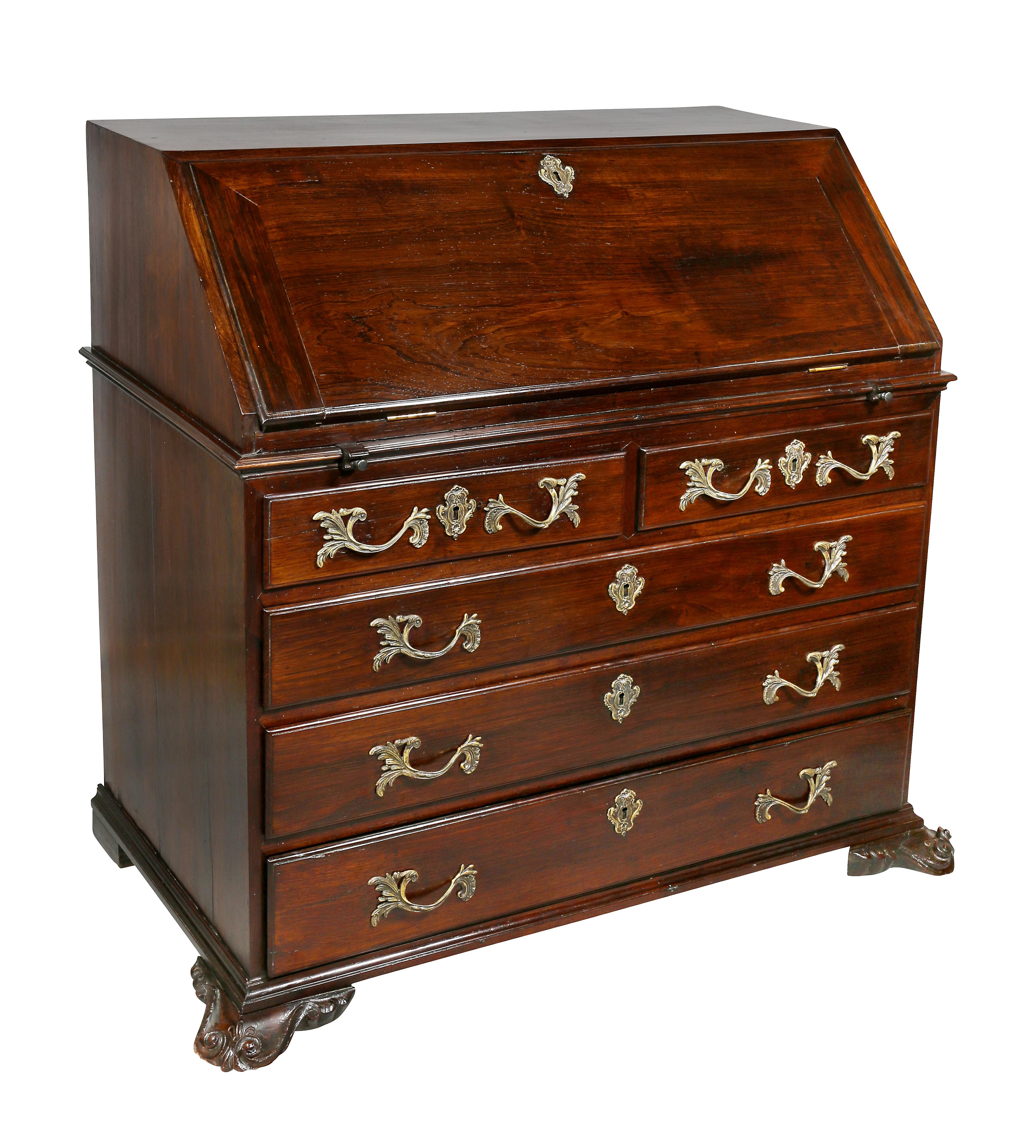 Made in Brazil and purchased as an antique in Rio De Janeiro in the 1950s. With slant lid top opening to a finely fitted compartment with drawers and cubbys and hidden compartments over two drawers over three drawers, shaped carved feet.