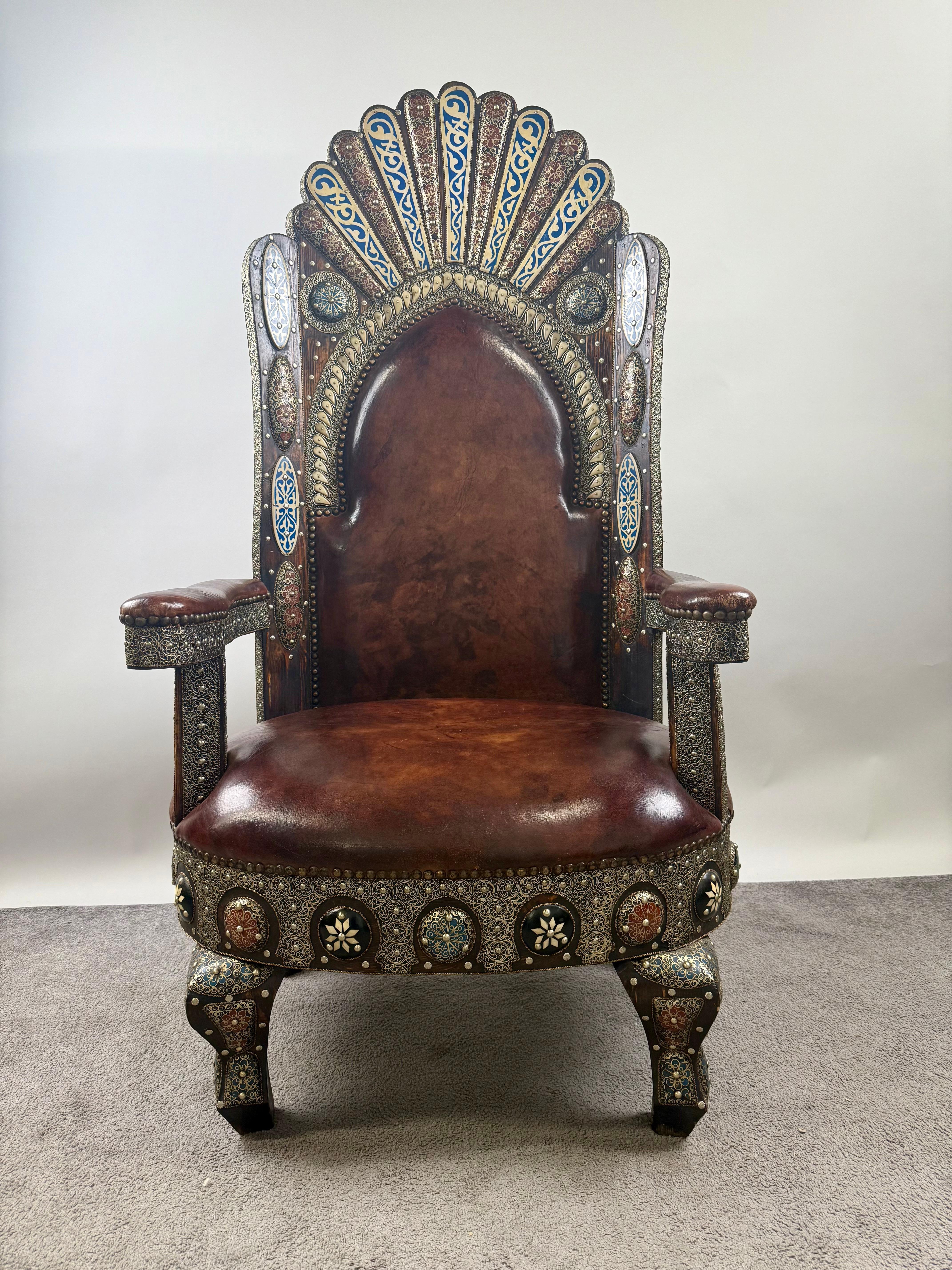 Portuguese Colonial Style Leather & Filigree Design Throne Chair :

This magnificent armchair is a striking embodiment of regal opulence and artisan mastery. Its stately silhouette is defined by a commanding high back, crowned with a radiant fan