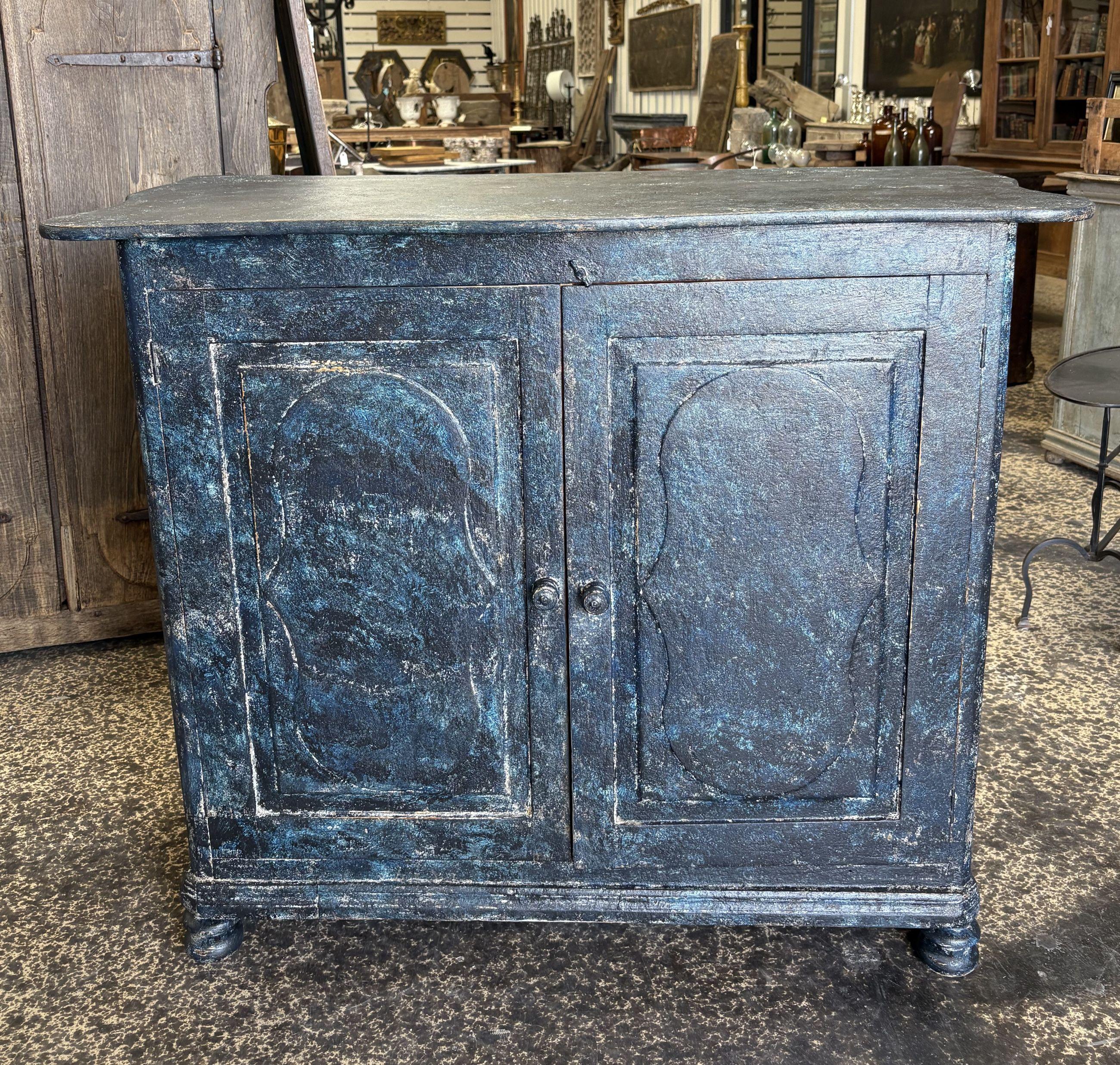 Un affascinante buffet primitivo a 2 ante dipinto dell'inizio del XIX secolo (stile gustaviano) proveniente dalla regione di Porto, in Portogallo. Questo pezzo è costruito con una bella superficie superiore scolpita e con pannelli delle porte