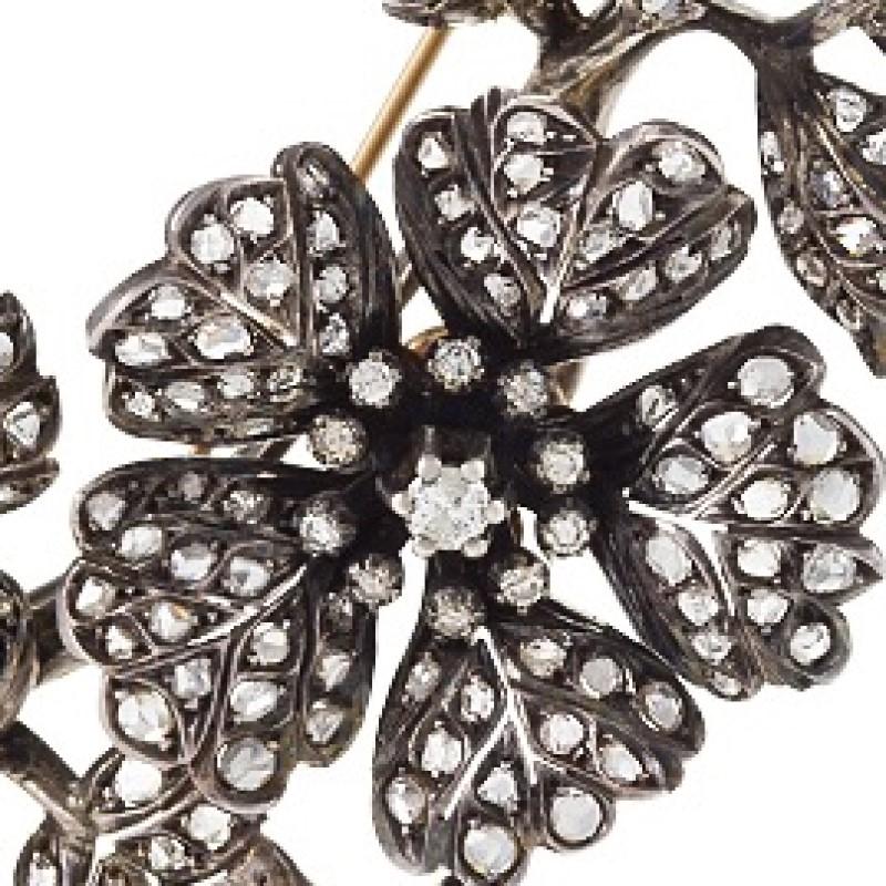 A Portuguese Georgian-Style 18 kt gold and oxidized silver brooch with diamonds. The brooch has 250 rose-cut diamonds with an approximate total weight of 5.50 carats, and 23 old European-cut diamonds with an approximate total weight of .50 carats. 