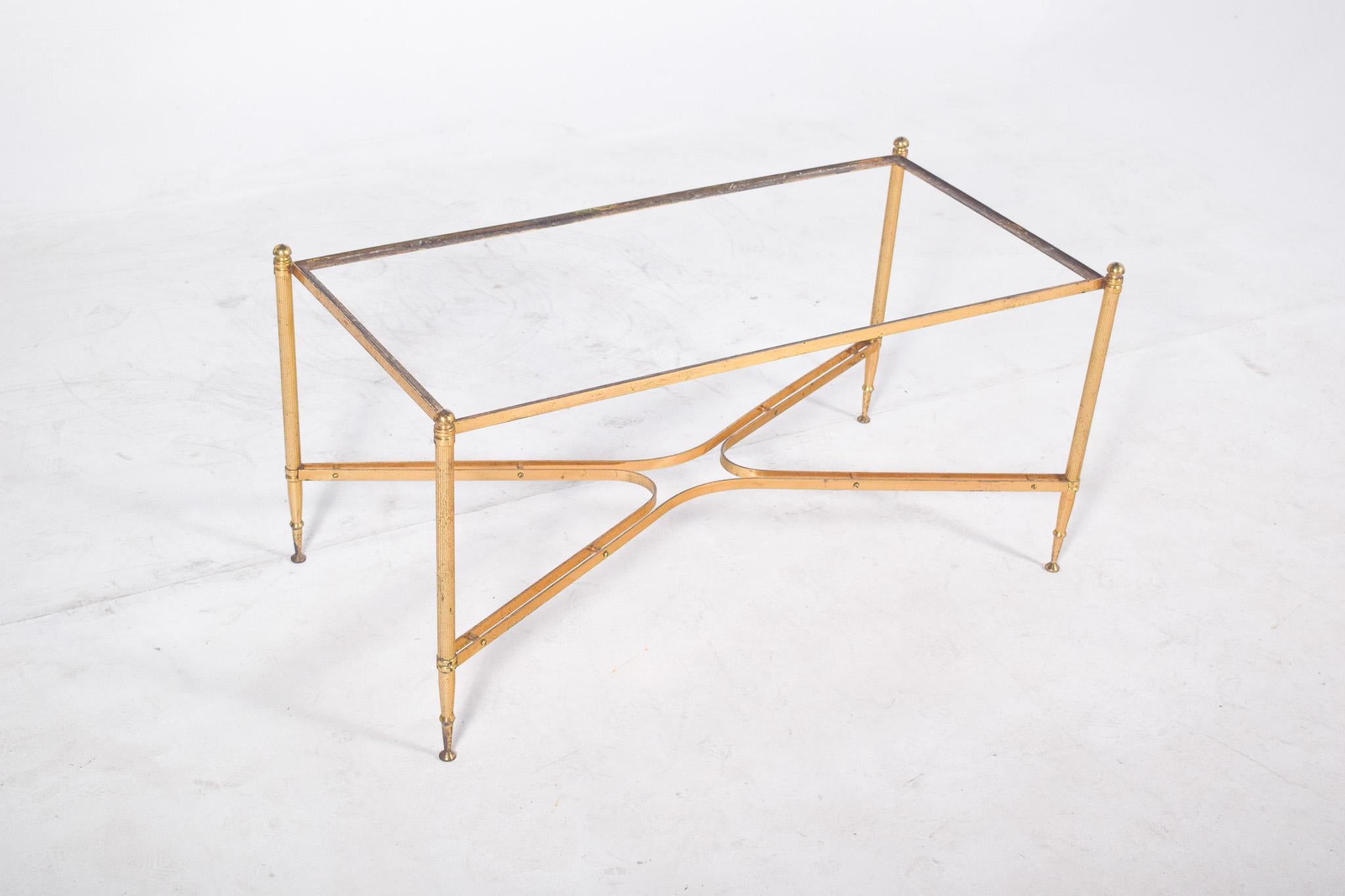 Oval table in wrought iron. The structure features delicate curvilinear arabesques all over the base, with the volute legs and the floral elements applied in gold metal highlighting the set with small touches of colour. The sinuous lines give the