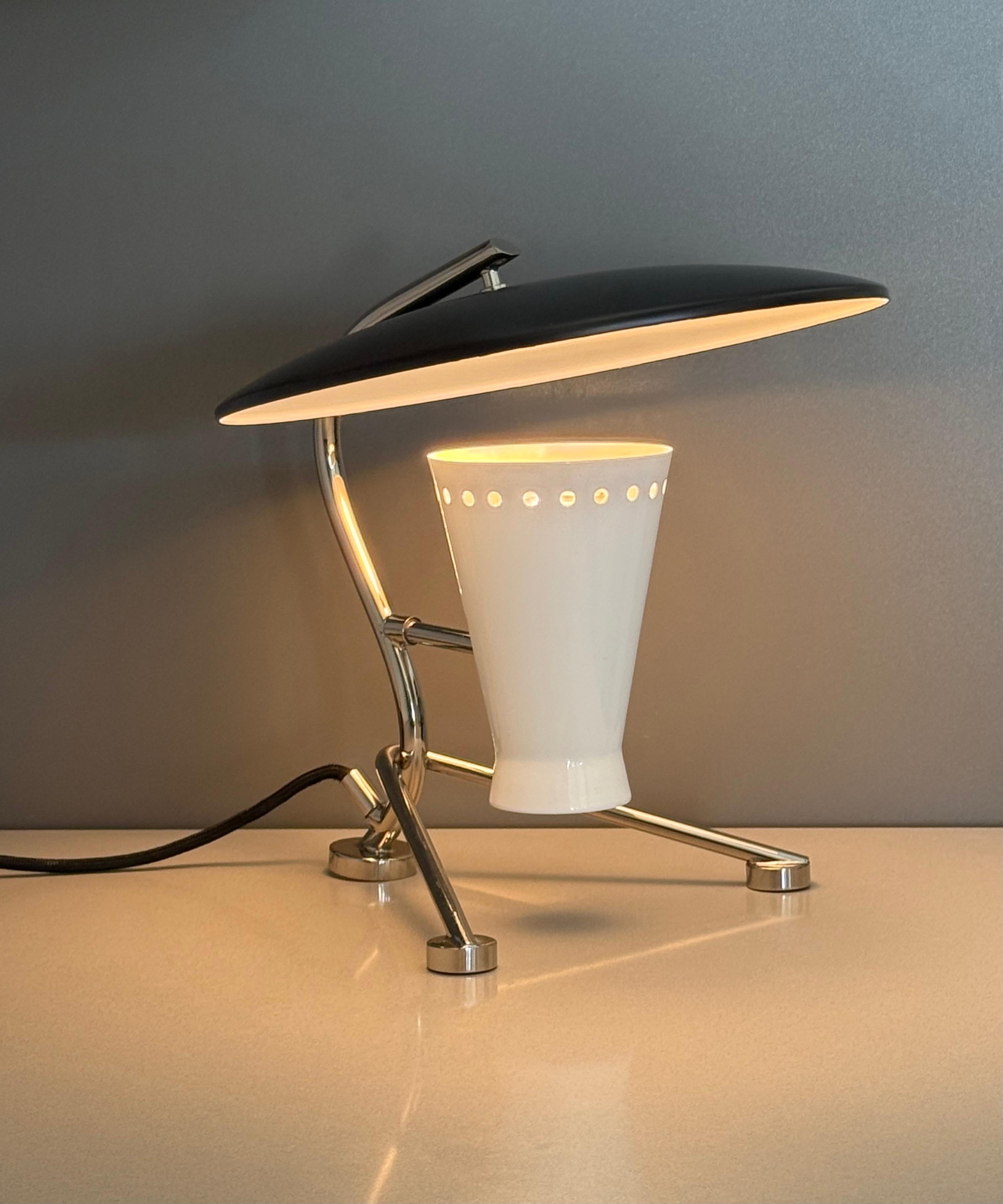 Portuguese polish nickel and matte black lacquer tripod mid-century moder style table lamp by Delightfull.

Wired for US it takes a small candelabra 40w Max bulb. 

Measurements: 11” Deep, 12” Wide, 11” High. 