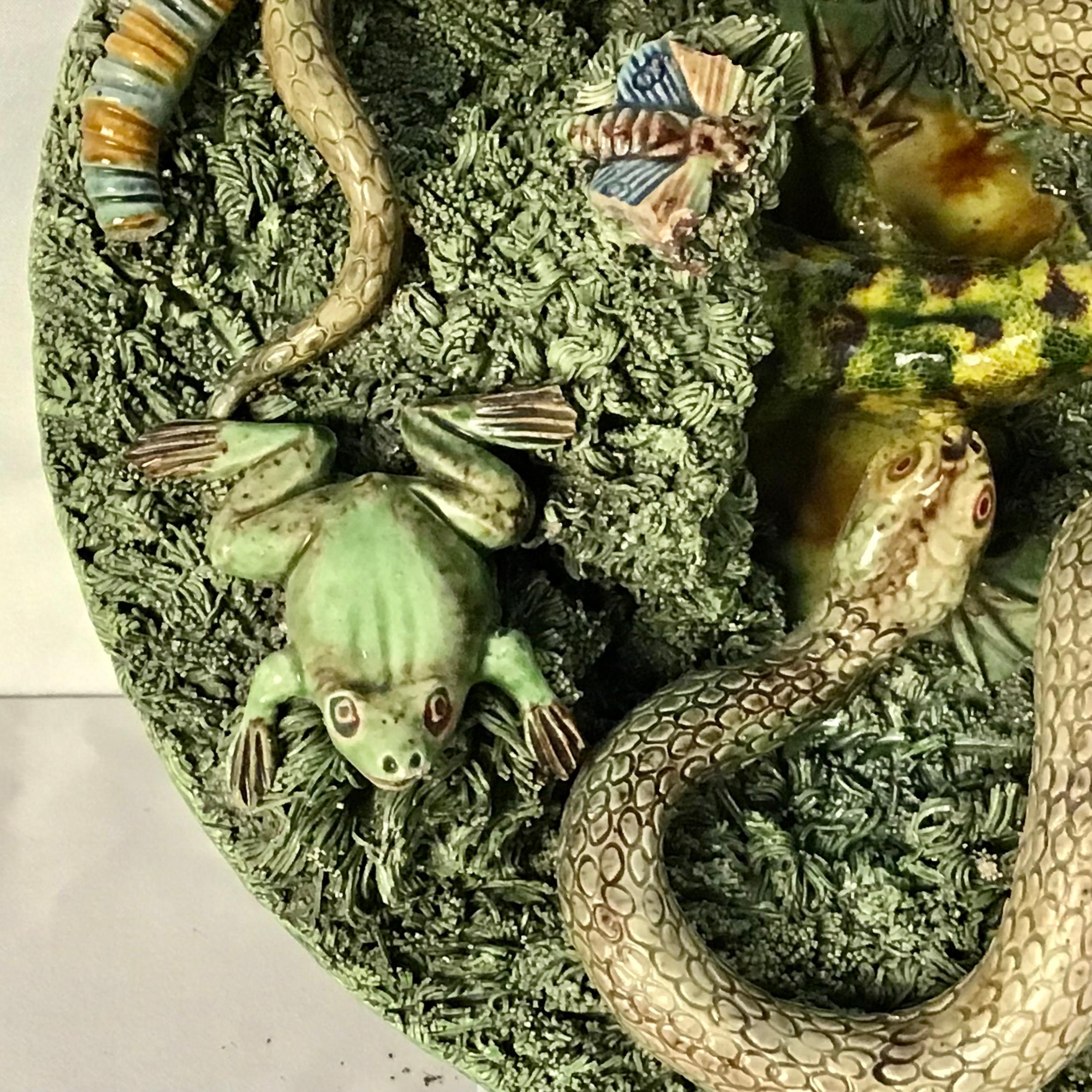 Portuguese palissy plate or charger with green grasses, coiled snake, grubs, lizard and butterfly. Signed: Jose A. Cunha, Caldas, Rainha, Portugal.