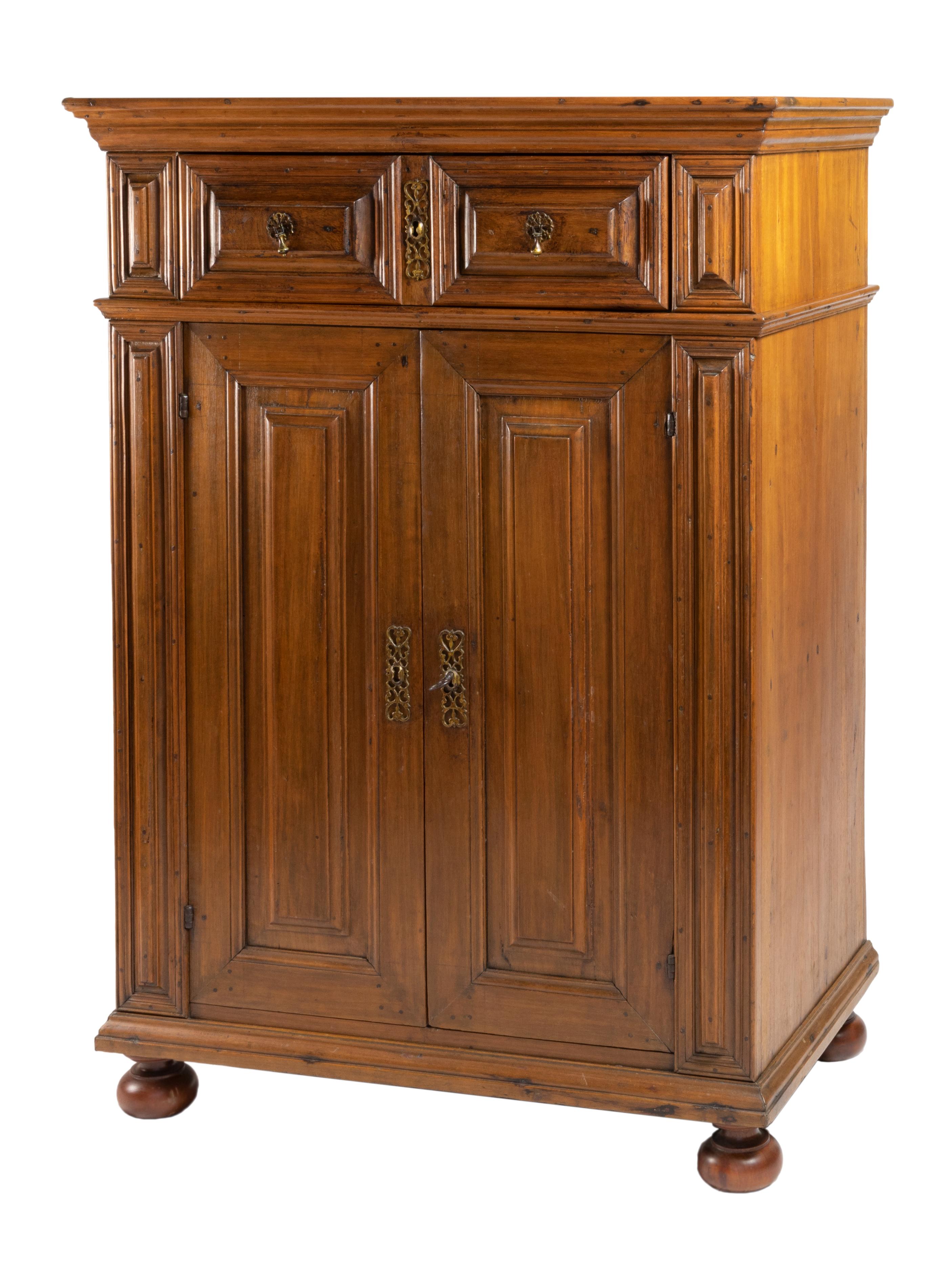 A rare and valuable cabinet from Portugal in great conditions made of Vinhatico (Madeira Mahogany or Canary Islands Mahogany) a rare wood from the Madeira and Canary islands in the North Atlantic Macaronésia. 
A two doors and two drawers piece, a