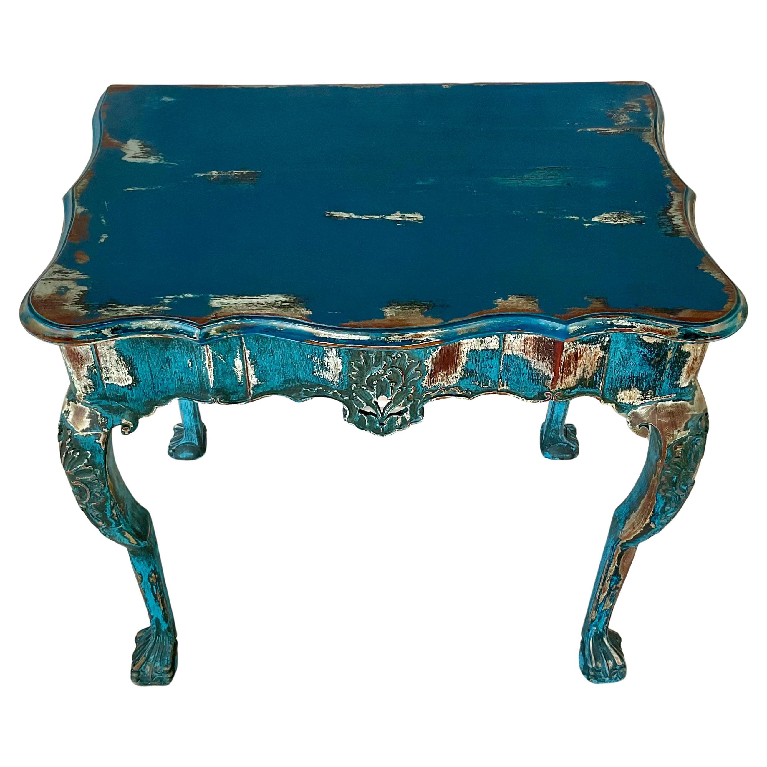 Mid-18th Century Portuguese Carved and Painted Rococo Console Table made of Brazilian Rosewood. The serpentine top rests above a shaped frieze carved on all sides with scrolling motifs and a central cartouche decoration. Raised on elegant cariole