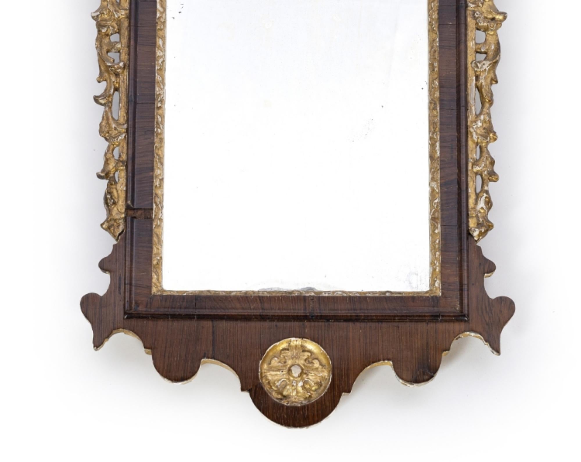 PORTUGUESE ROSEWOOD WALL MIRROR 18th century

Portuguese from the 18th century, 
rosewood veneer, carved and gilded wood, architectural cornice, winding and flower decoration. Defects for the age.
DIM.: 80 x 43 cm.