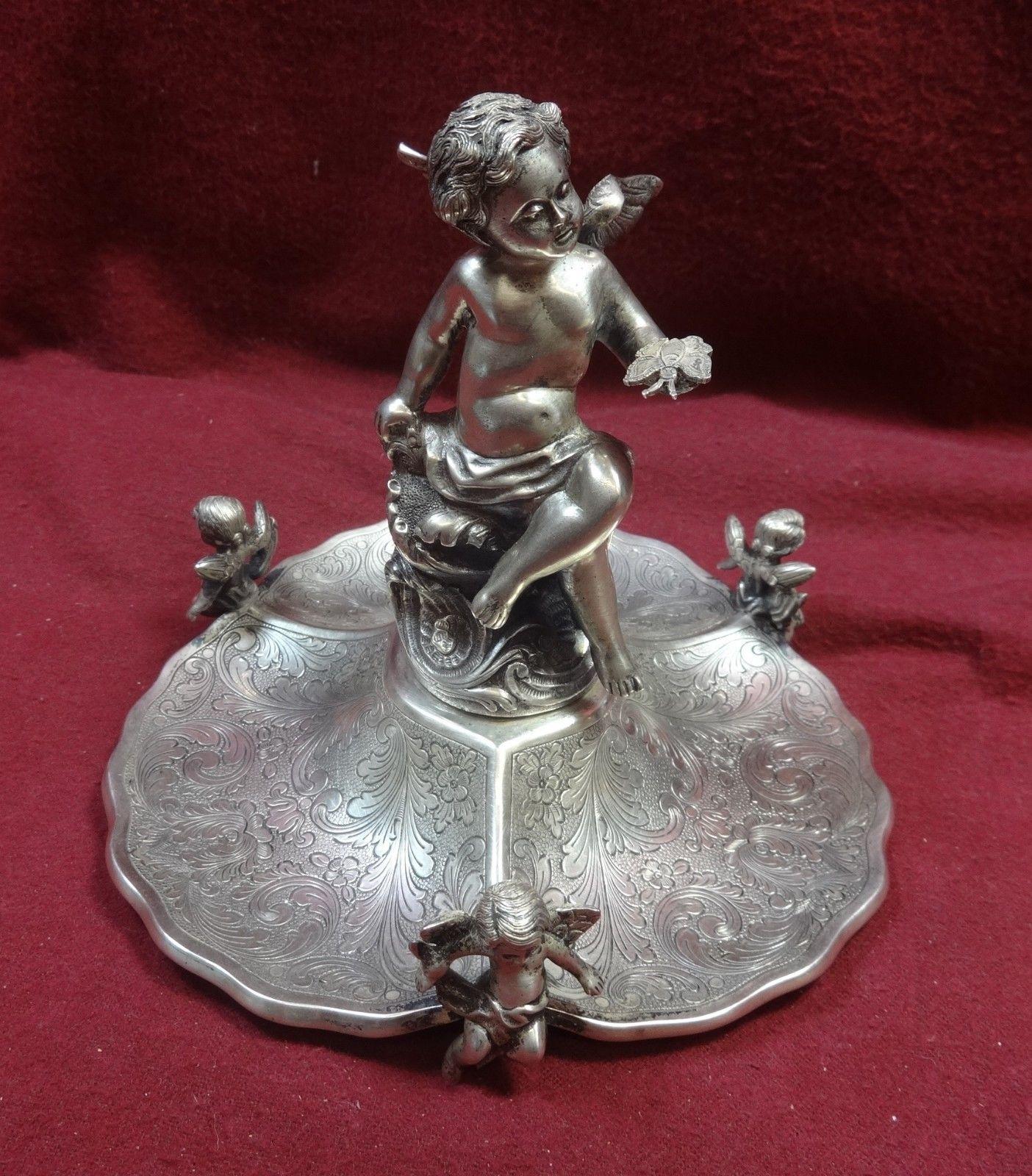 Portuguese sterling silver figural Portuguese Cherub stand with cherub finial and 3 Cherub feet 5 X 6. Weight is 18.10 troy ounces. It is not monogrammed and is in excellent condition. 

 