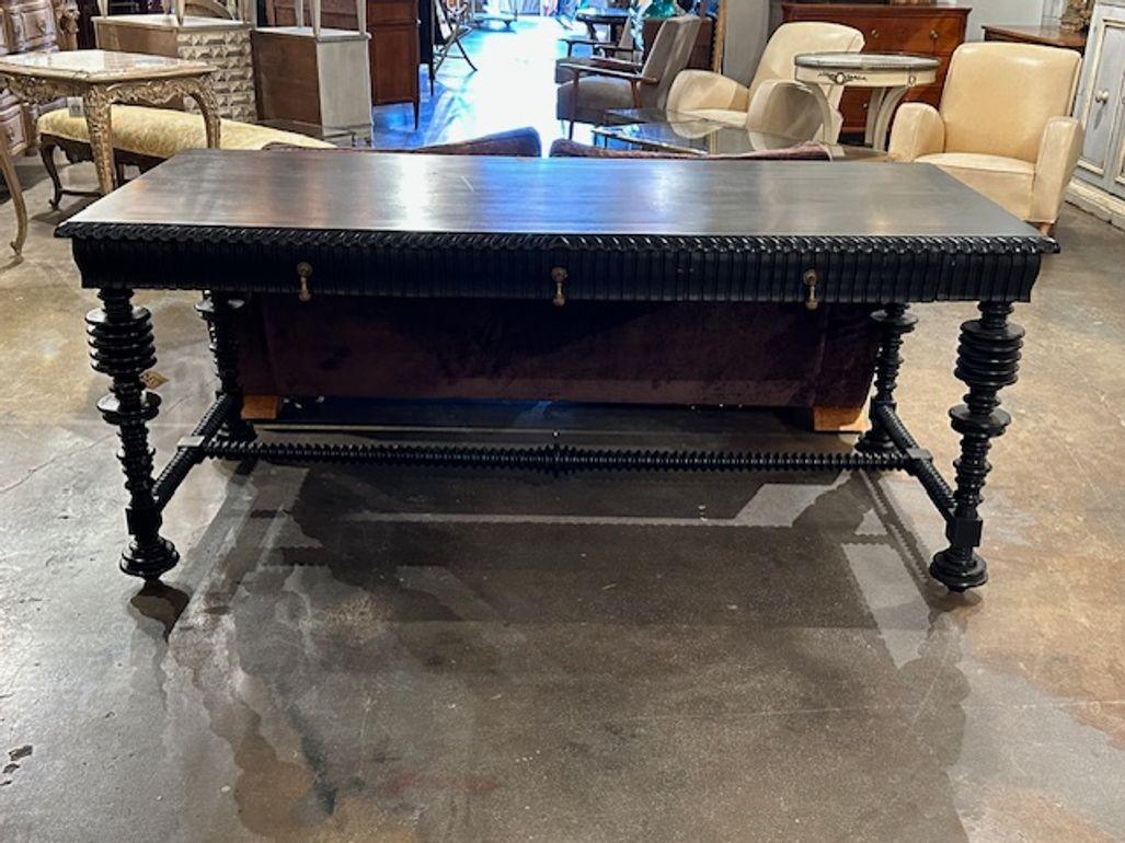 Handsome Portuguese style barley twist carved and ebonized library table. Circa 1980. A fine addition to any home!