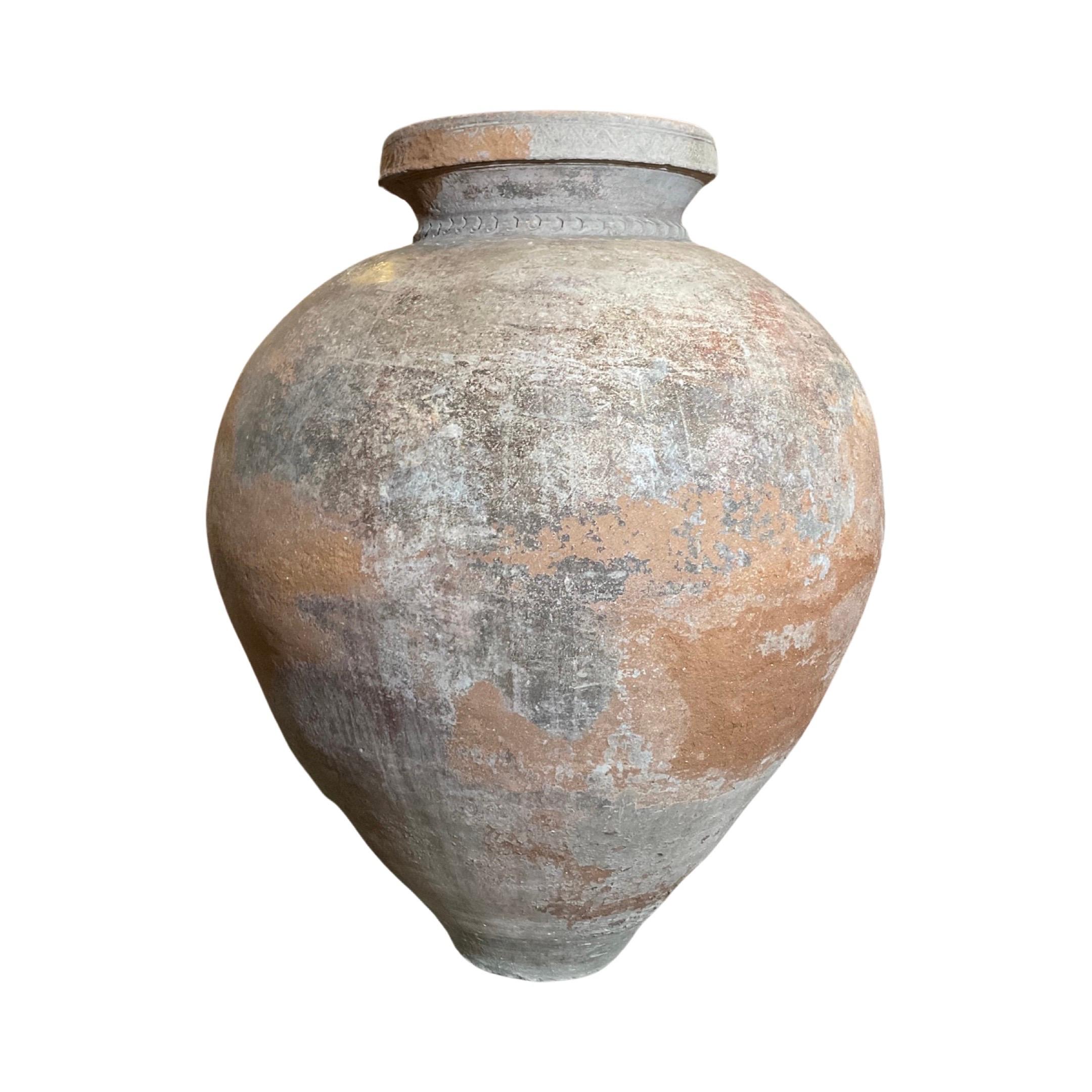 This stunning Portuguese terracotta vessel dates back to the 18th century and features intricately detailed carvings surrounding the opening. Crafted from terracotta, its unique design is sure to make a statement in any home.