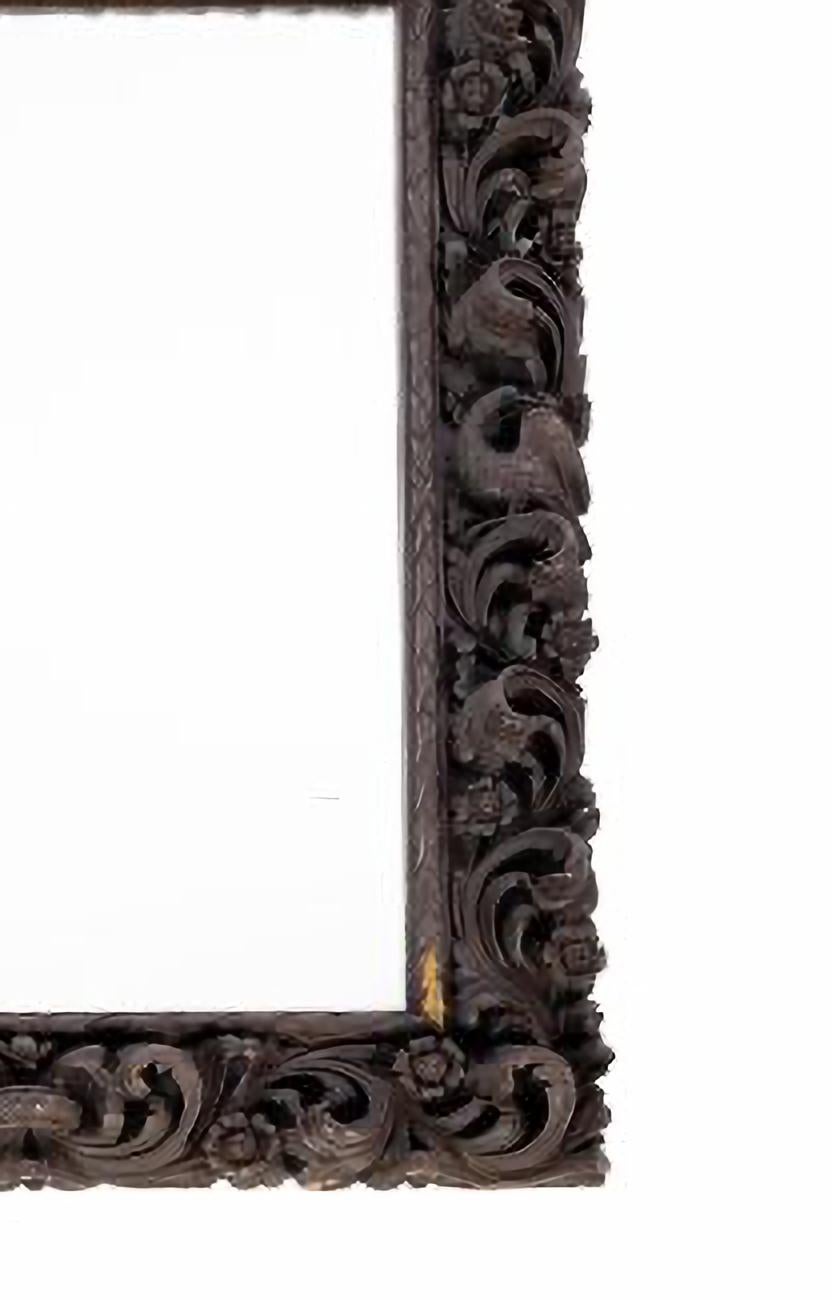 WALL MIRROR

Portuguese, from the 19th century.
in brown with profuse decoration of vegetal elements.
Dim.: 133 x 80 cm;
total: 165 x 94 cm.
good conditions