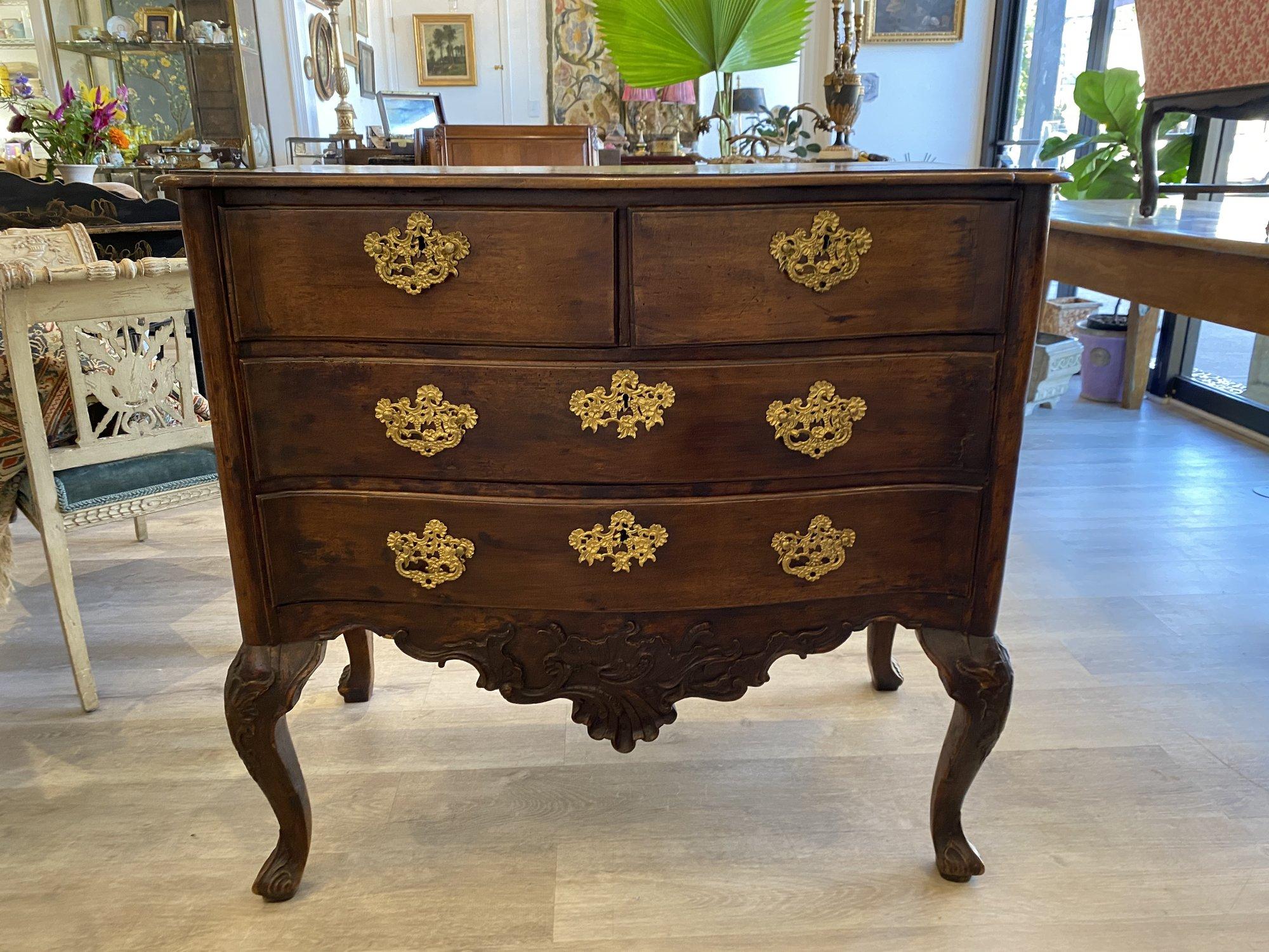 Portuguese walnut commode, 18th century, serpentine top over conforming front having two small drawers of two wide drawers over a and finely carved lower apron on cabriole legs, both front and rear having carved knees over semi-scrolling acanthus