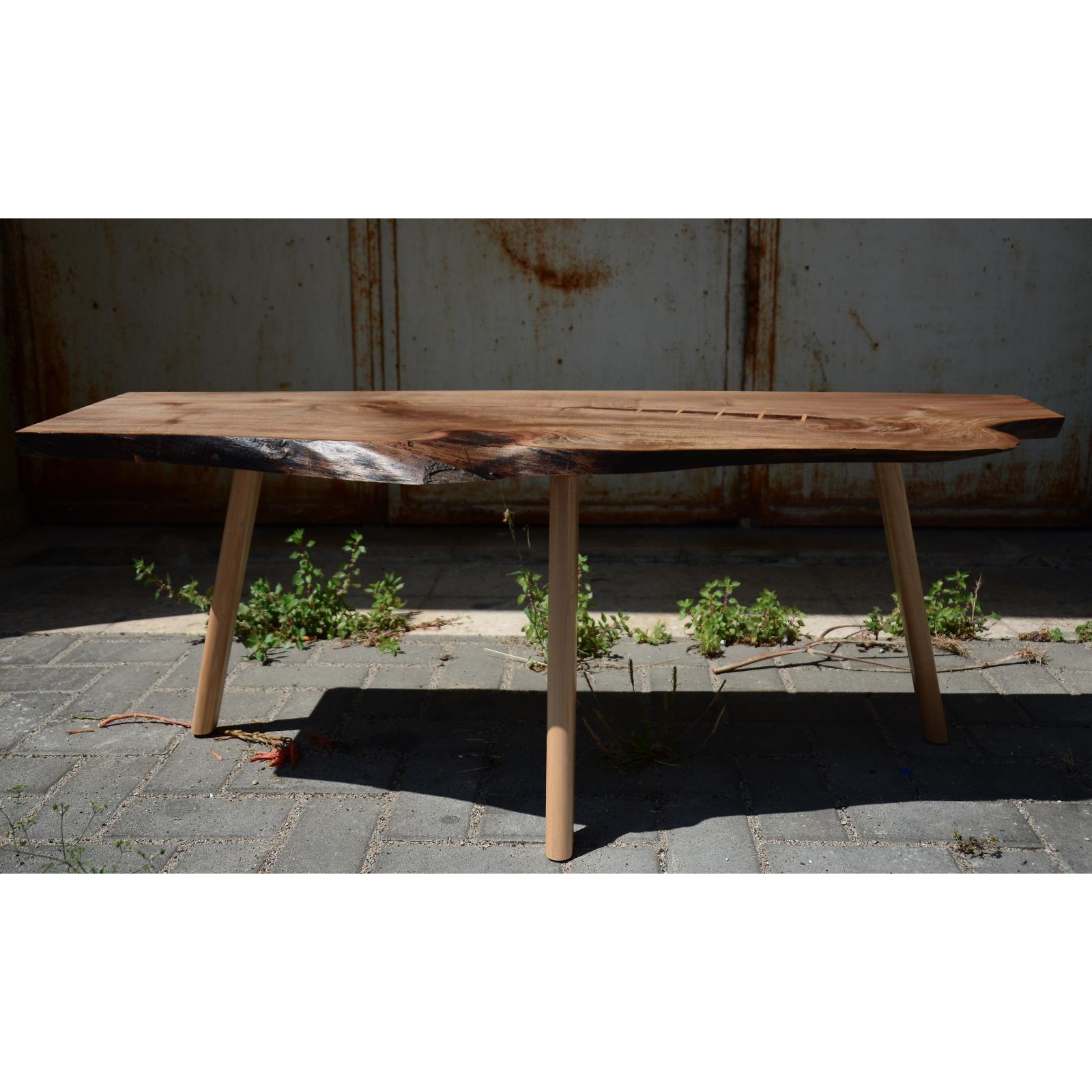 The Portuguese Walnut has a beautiful and distinct golden brown grain that goes perfectly with the light yellow Hard Maple in the feet and the table top inlays.

We designed this piece with a naturalistic aesthetic, where Nature is the main creator