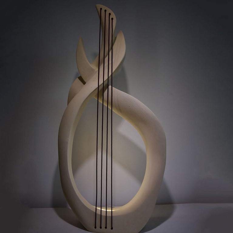 Captivating in its simplicity, this light-sculpture is inspired by the Olympian god of the sea symbolized by sinuous forms and dark brown ropes extending from the base recalling his wavy hair and pronged spear. Signed by the artist, this unique