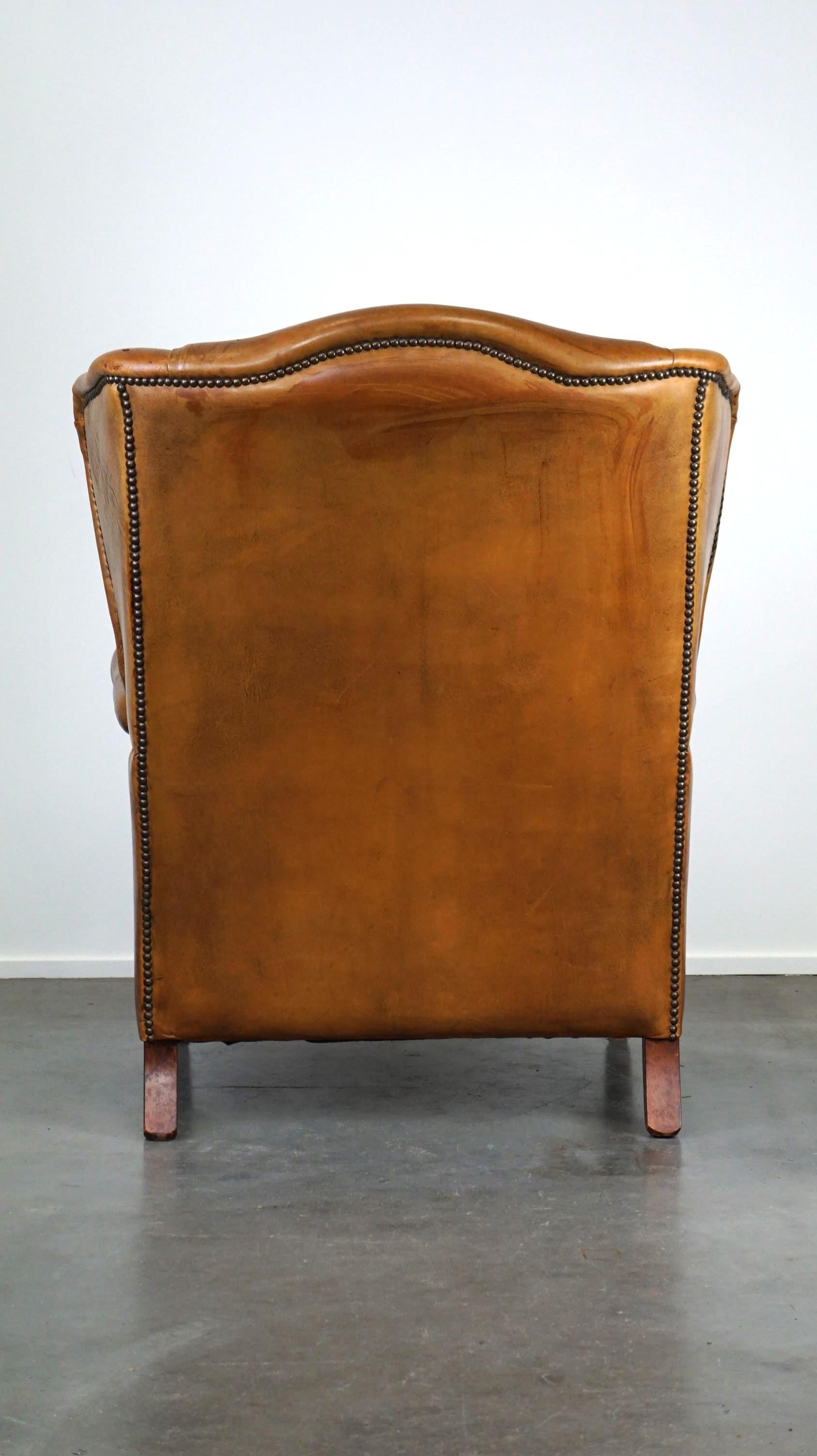 Hand-Crafted Positively lived-in sheepskin leather wing chair with pleasant seating comfort