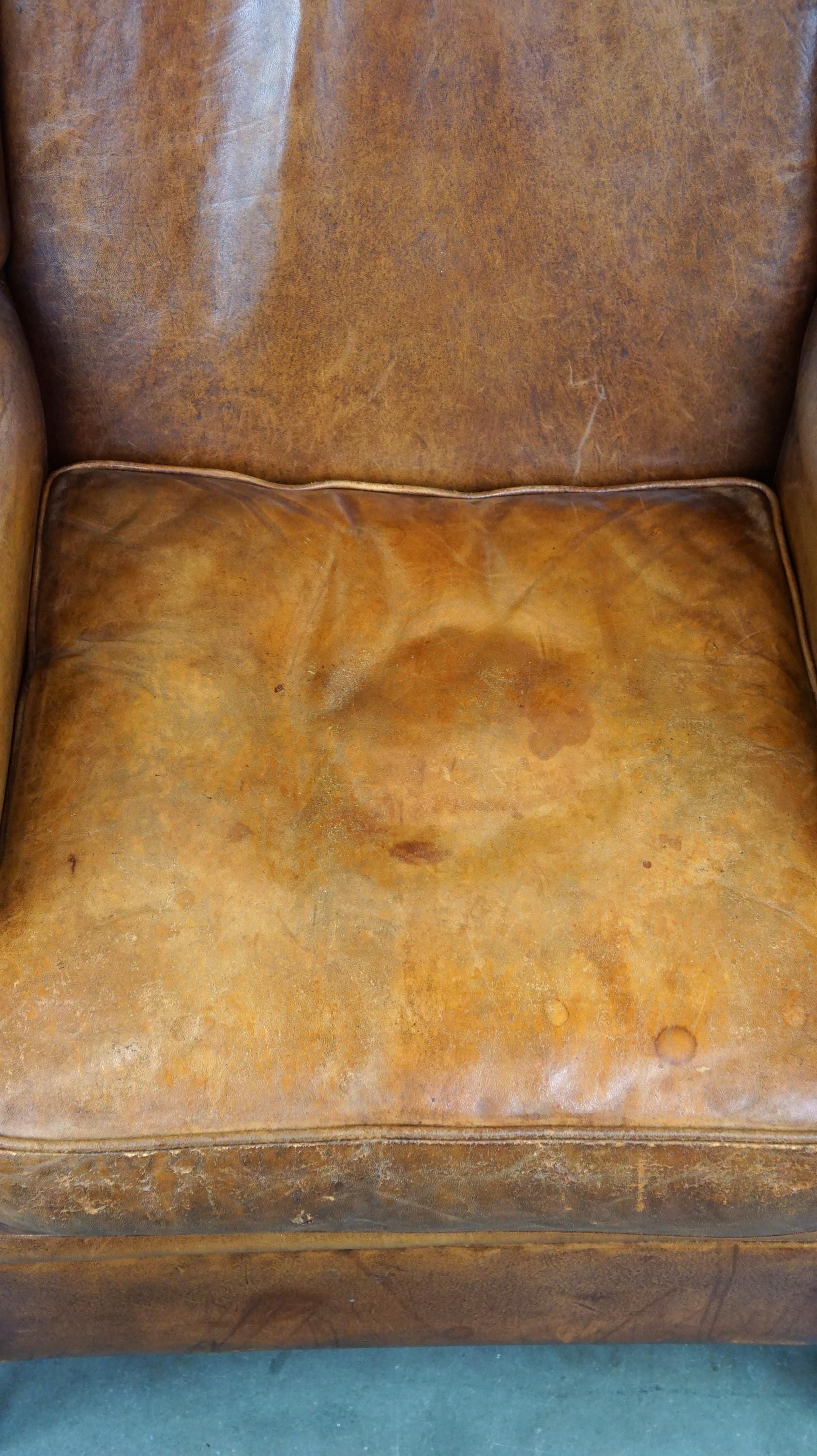 Contemporary Positively lived-in sheepskin leather wing chair with pleasant seating comfort