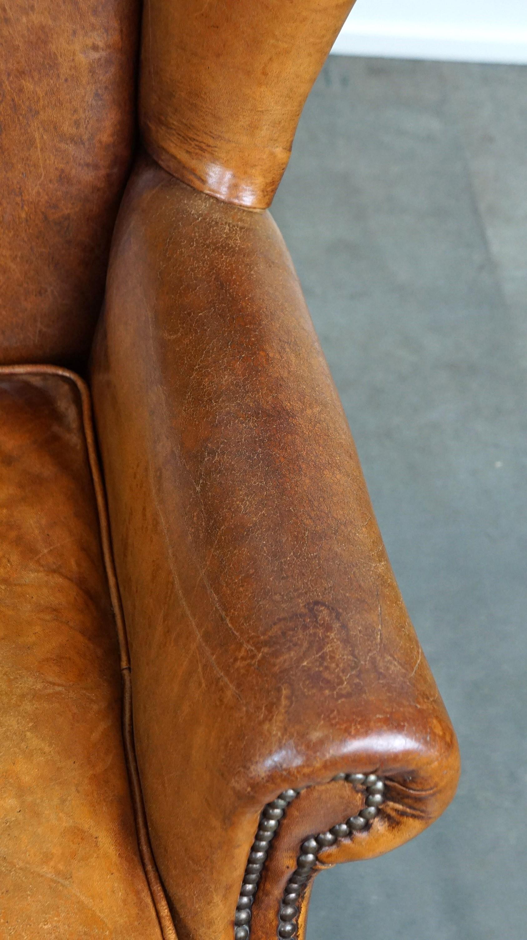 Positively lived-in sheepskin leather wing chair with pleasant seating comfort 1