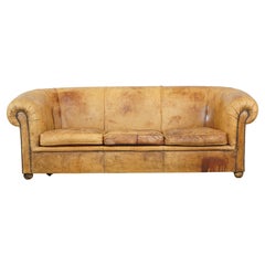 Positively well-lived and characterful Used sheepskin leather 3-seater sofa