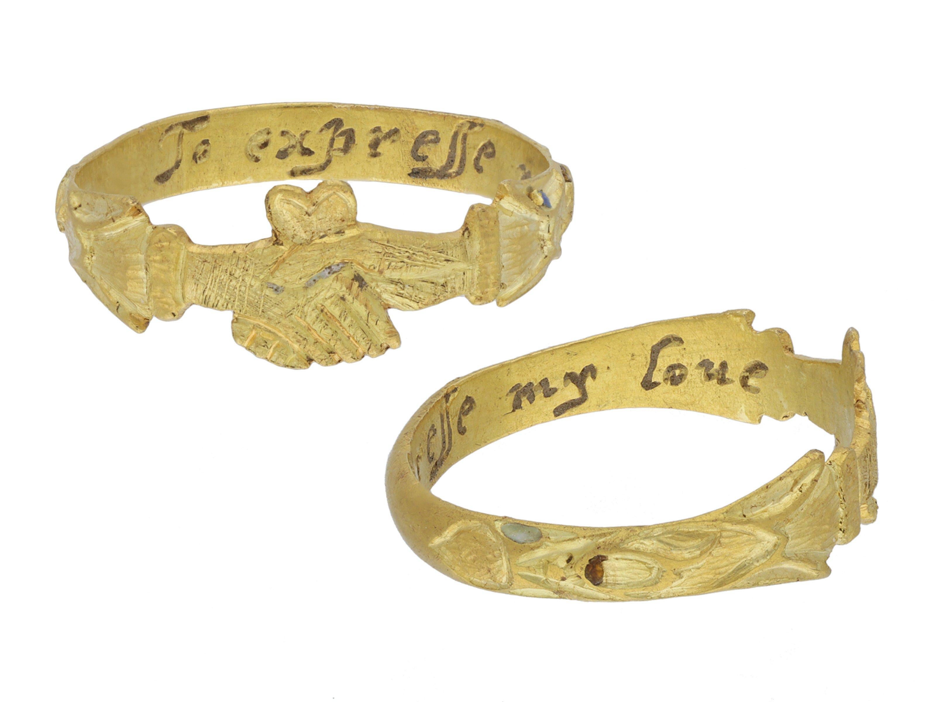 Post Medieval fede ring with posy, circa 1650-1720. A yellow gold fede ring, finely carved to centre with a pair of clasping hands, set above with a heart shape motif, leading to intricate shoulders with ornate cuff detailing with traces of yellow,