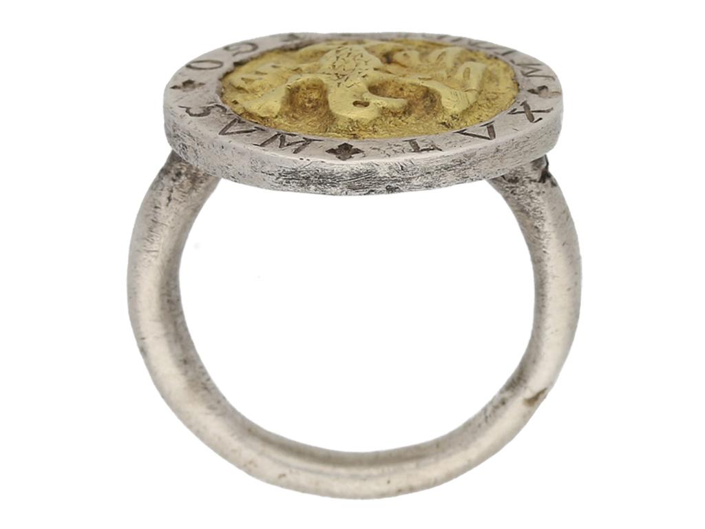Post Medieval silver 'I AM THE LIGHT OF THE WORLD' ring with eagle. Set to center with a circular silver gilt plaque with an eagle with wings spread wide in relief, encircled by a silver frame engraved with Latin 'EGO + SUM + LUX + MVUNDI +',