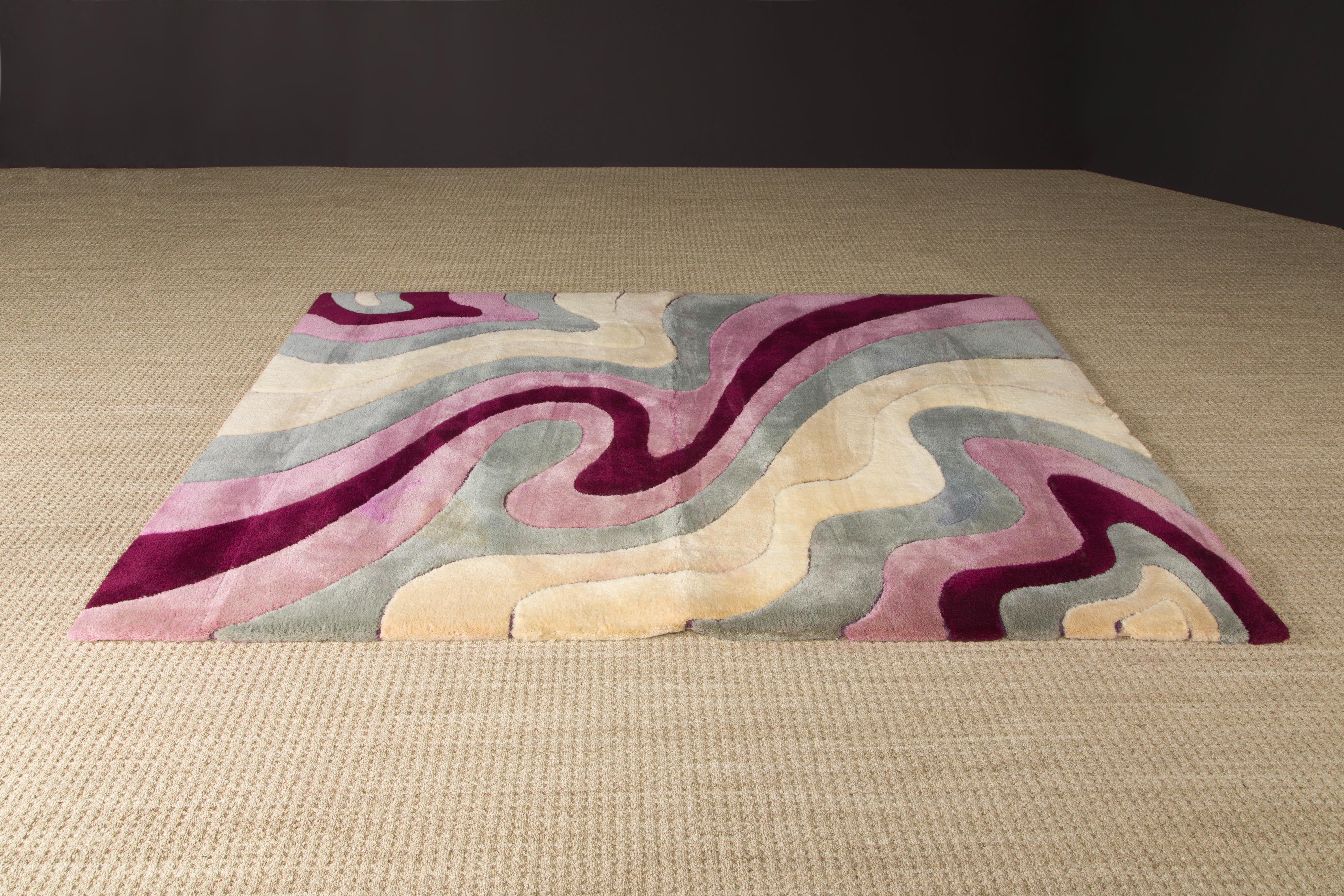 This Post-Modern area rug by Edward Fields is signed and dated 1982 and made from 100% virgin wool. Featuring abstract shaped of different shades of pink, purple, gray and beige, and measures 96