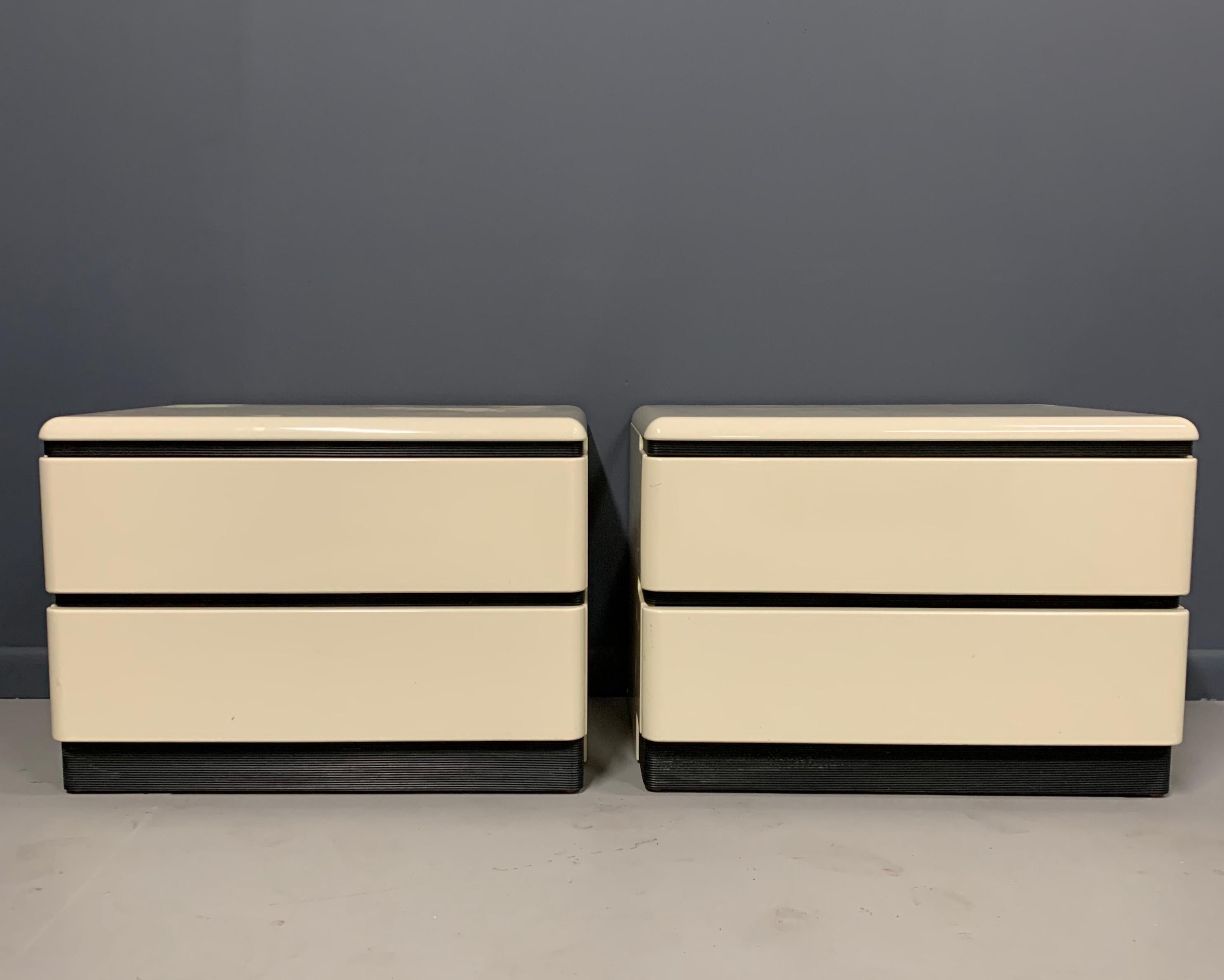These great nightstands are a lacquered ivory color with ribbed black rubber accents. They look like they are out of the movie 2001 A Space Odyssey.